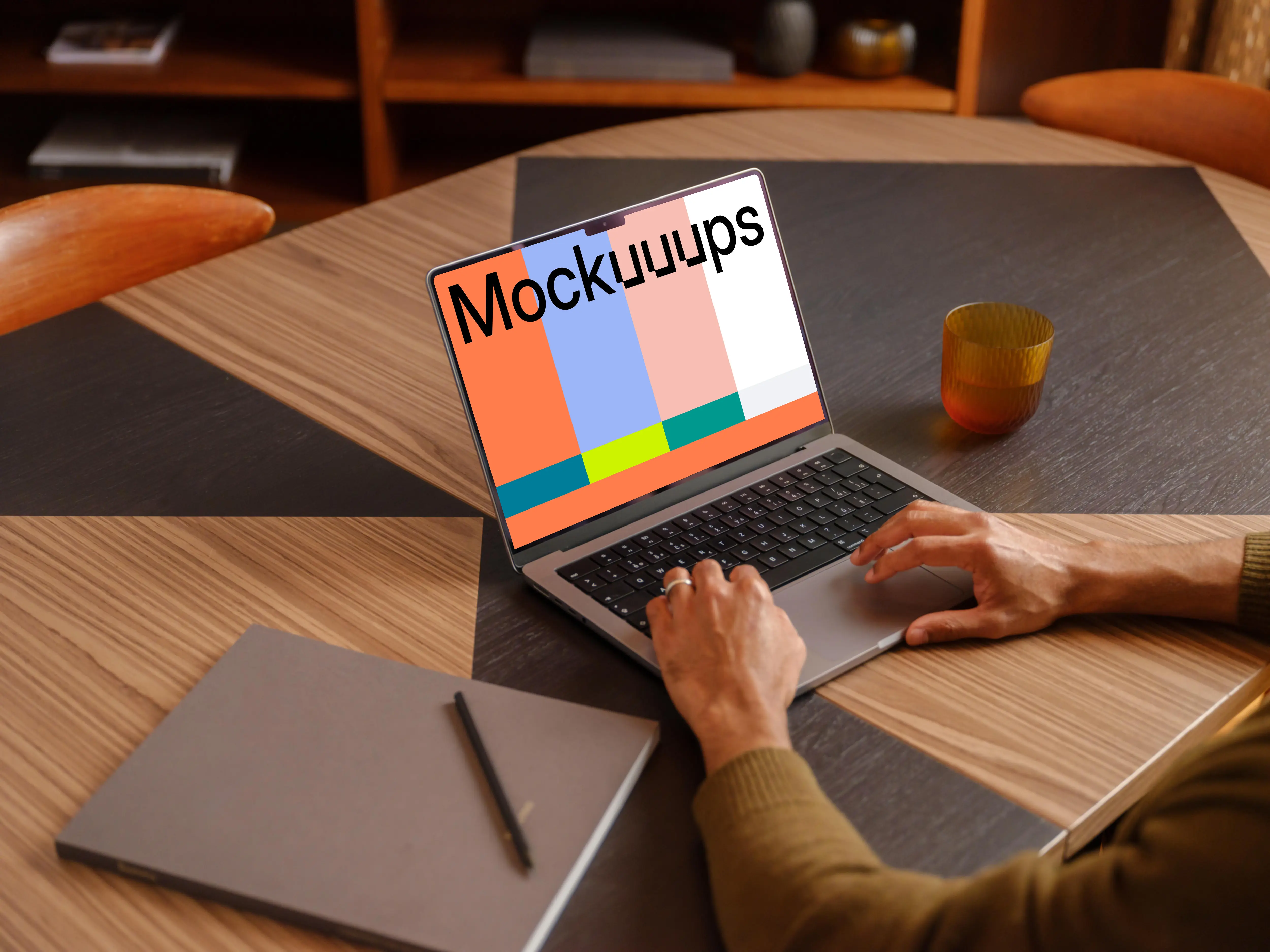 Office environment and man typing on a laptop mockup