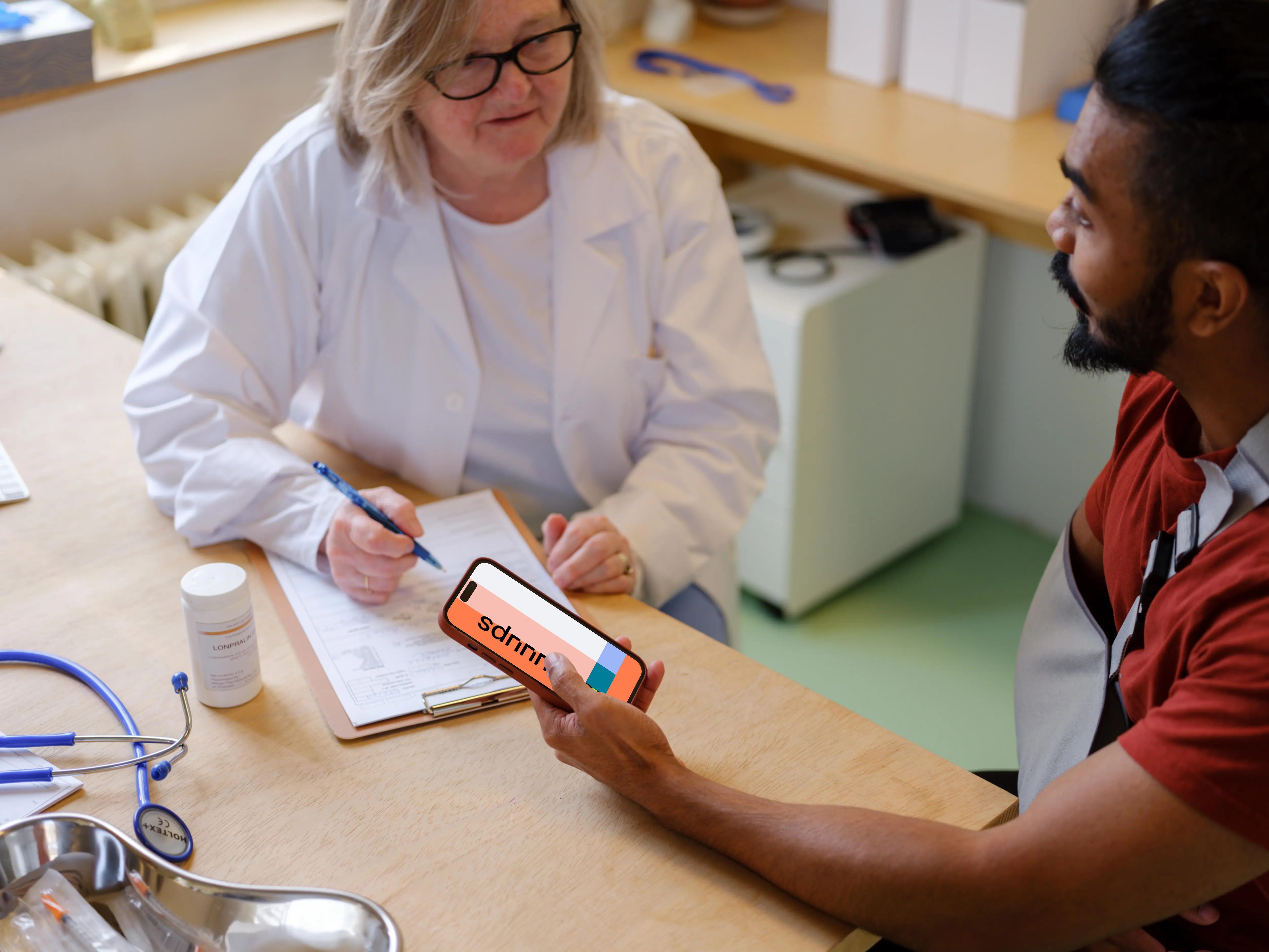 Patient holding an iPhone in doctor’s office