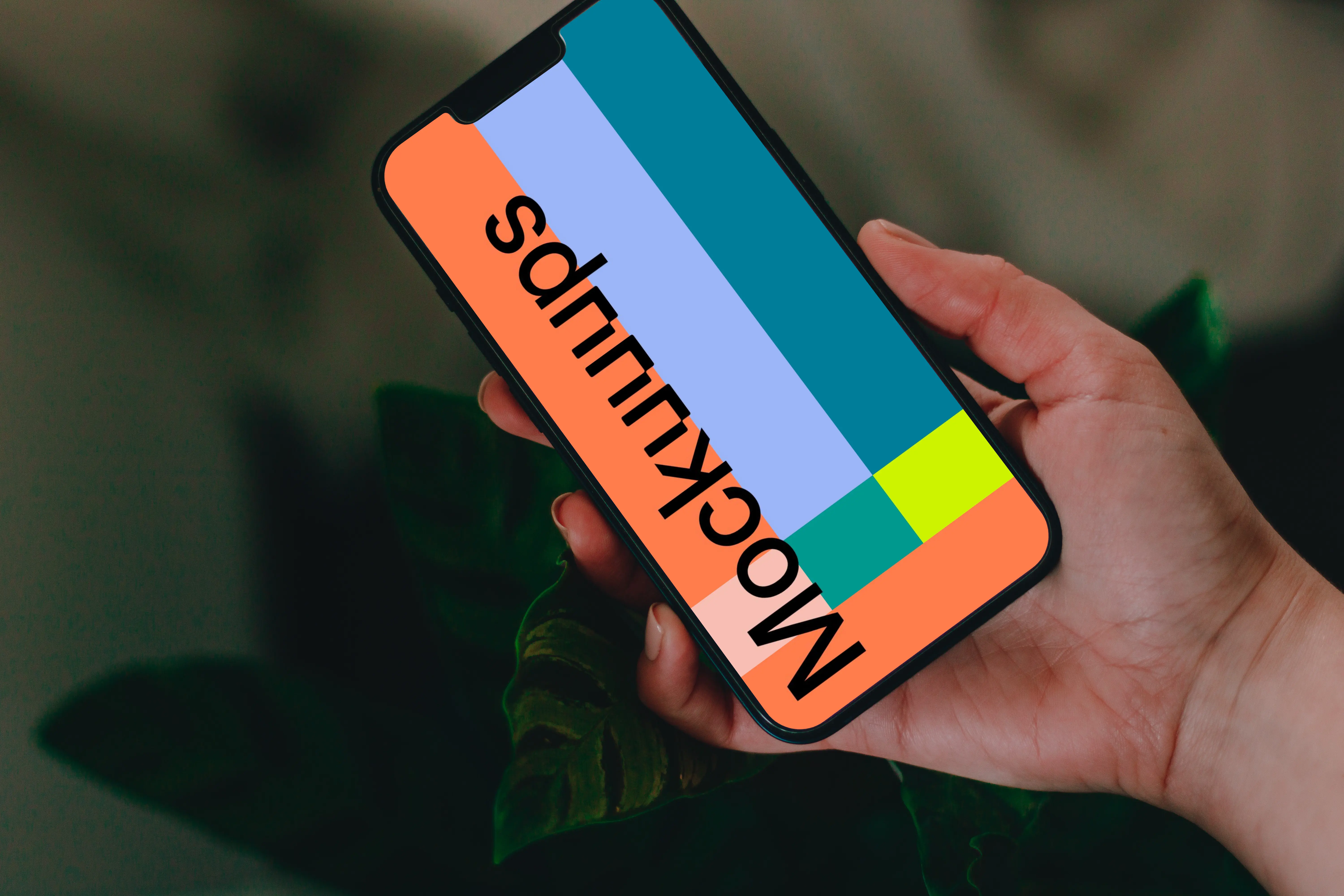 Person holding up an iPhone 13 Pro mockup