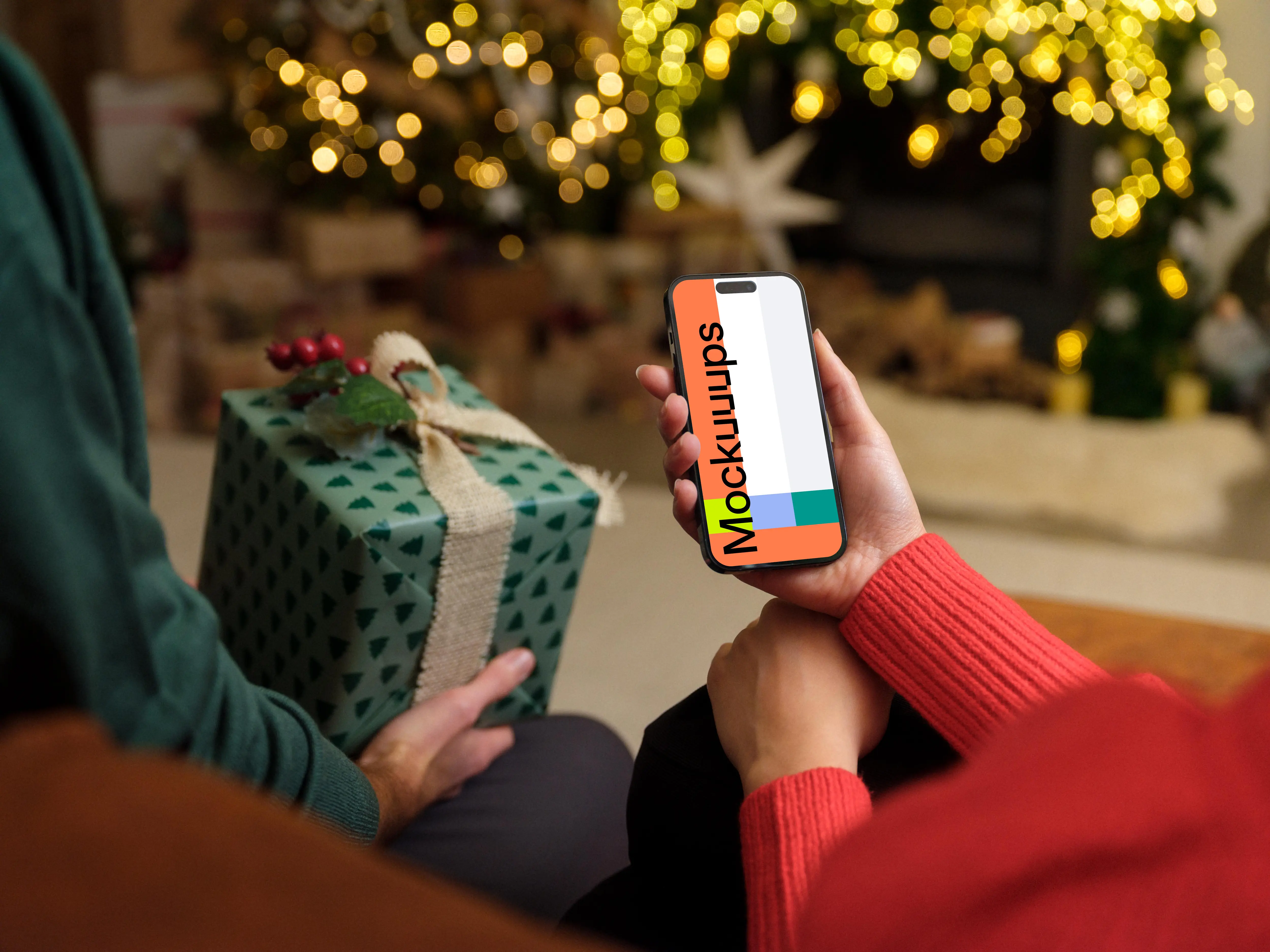 Person in red sweater holding a phone mockup