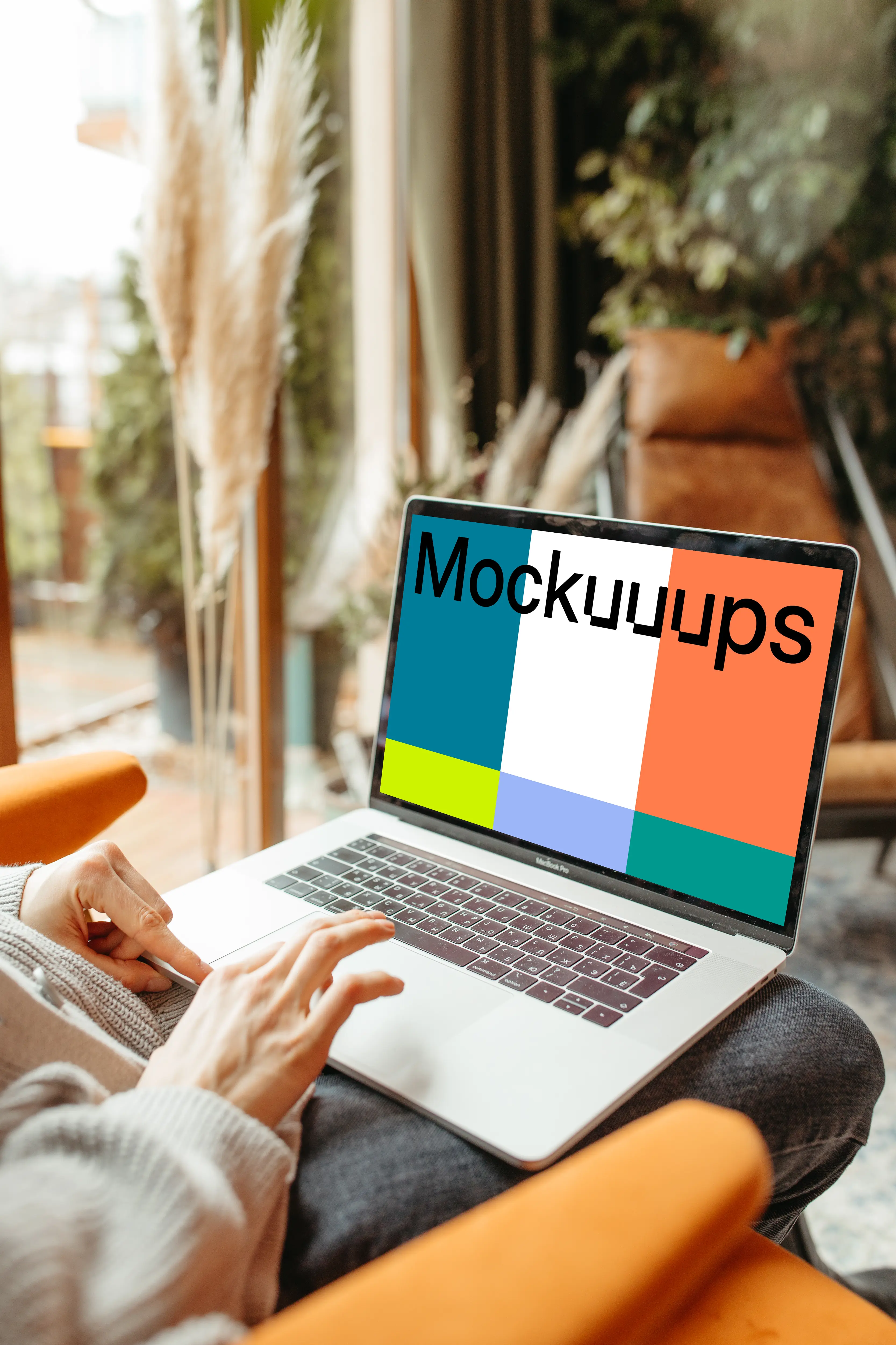 Person typing on a MacBook Pro mockup