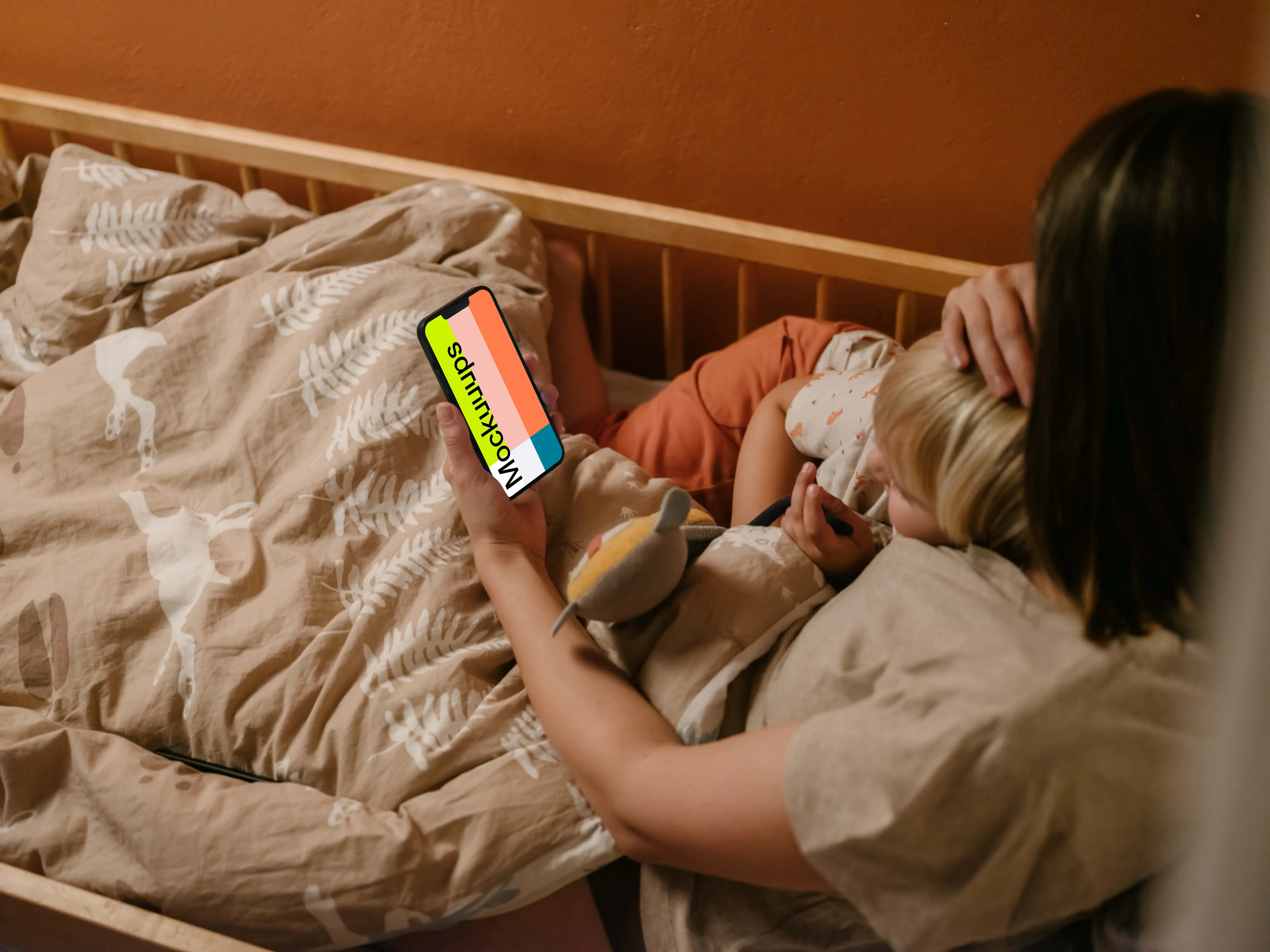 Person's hand holding an iPhone mockup