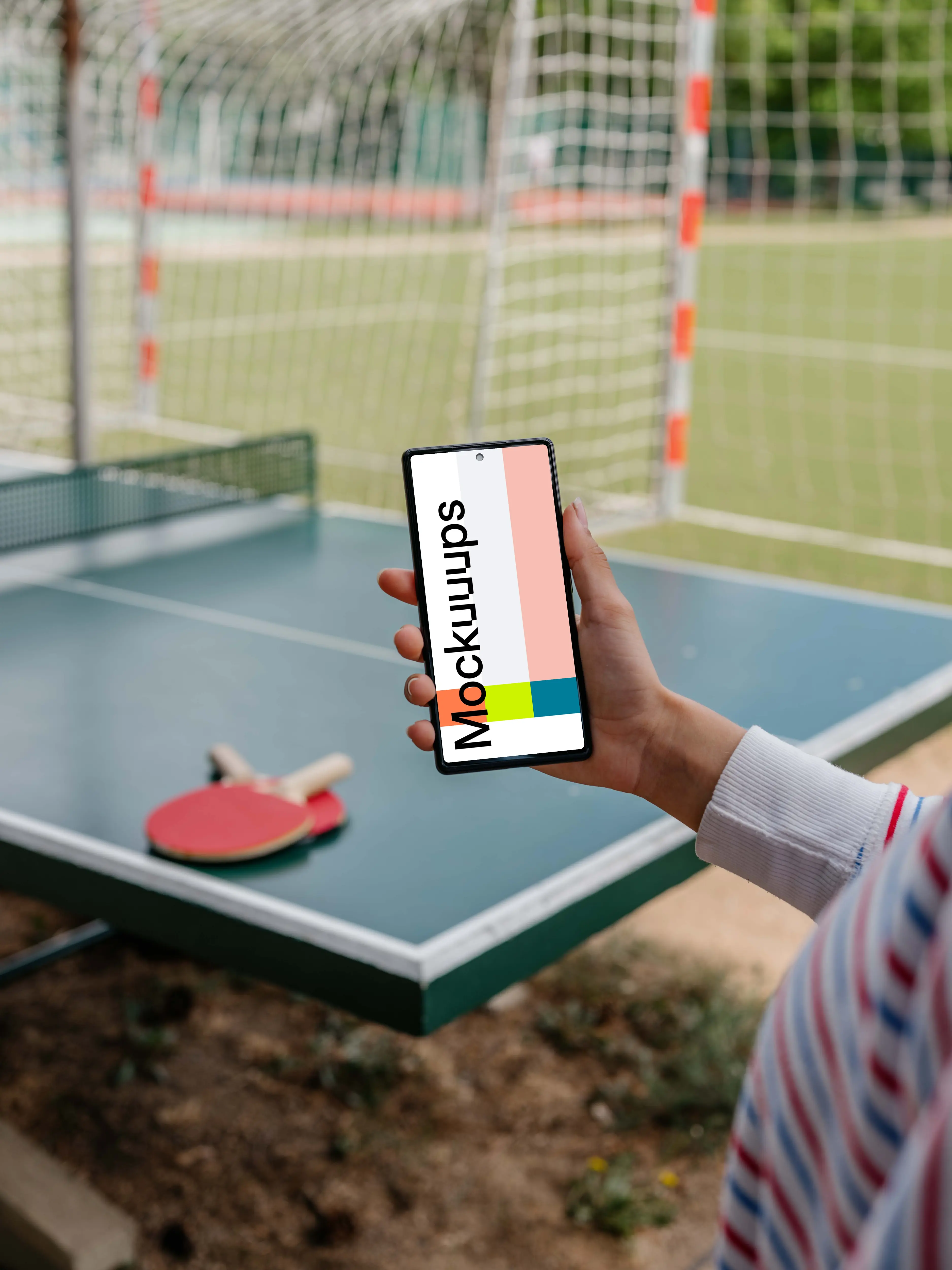 Ping-pong player holding a phone mockup