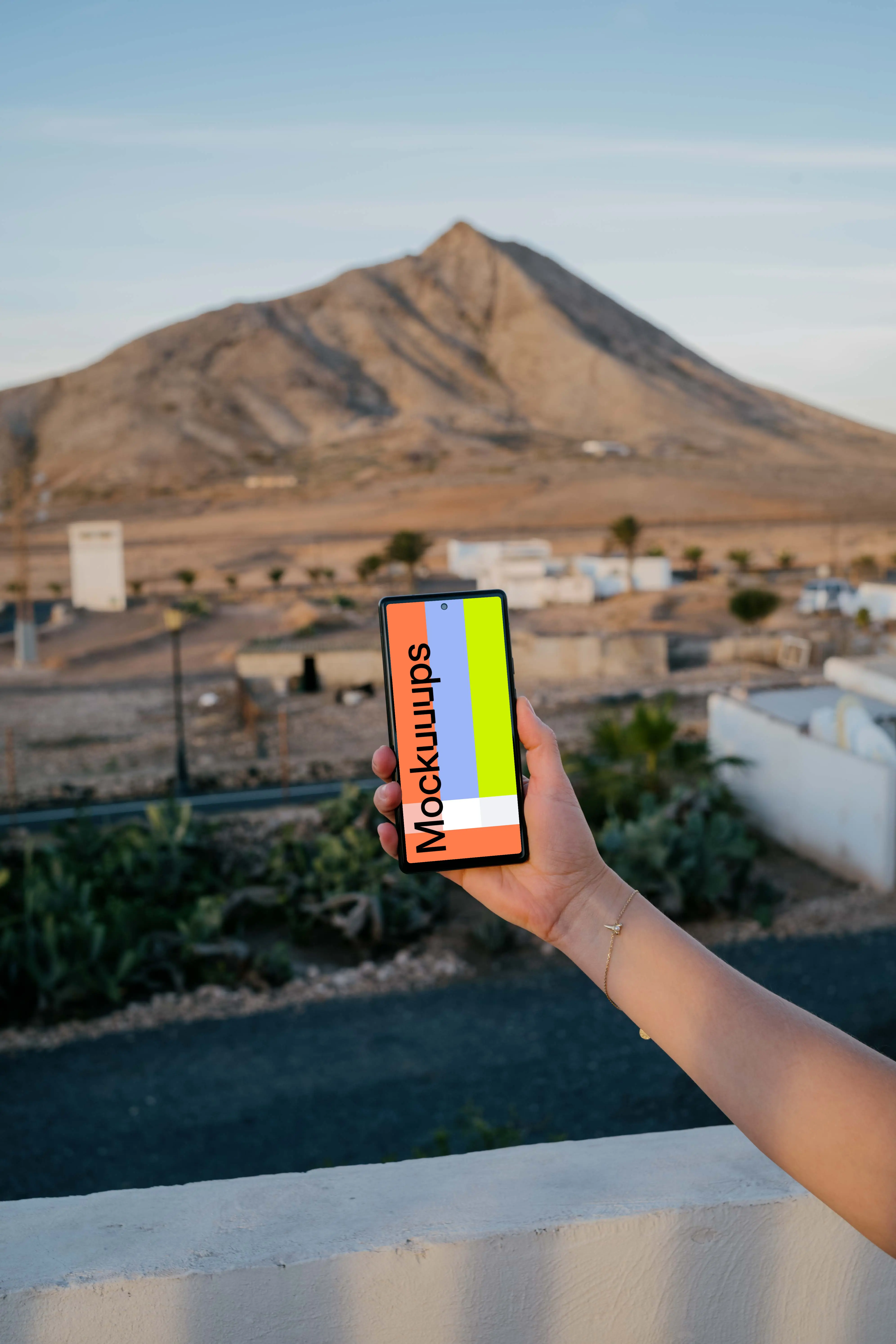 Smartphone mockup held by user over an open field