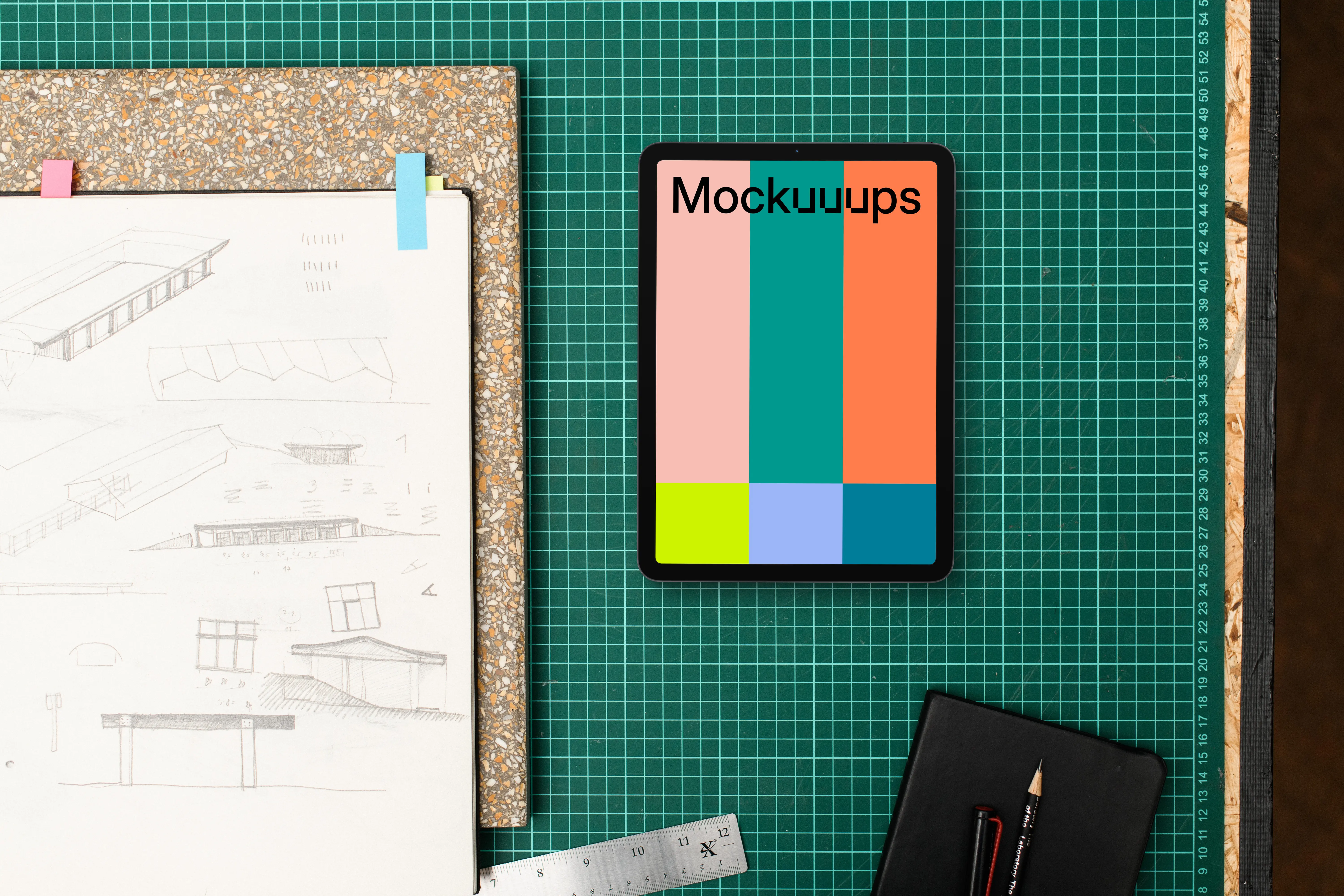 Tablet mockup alongside architect drawings