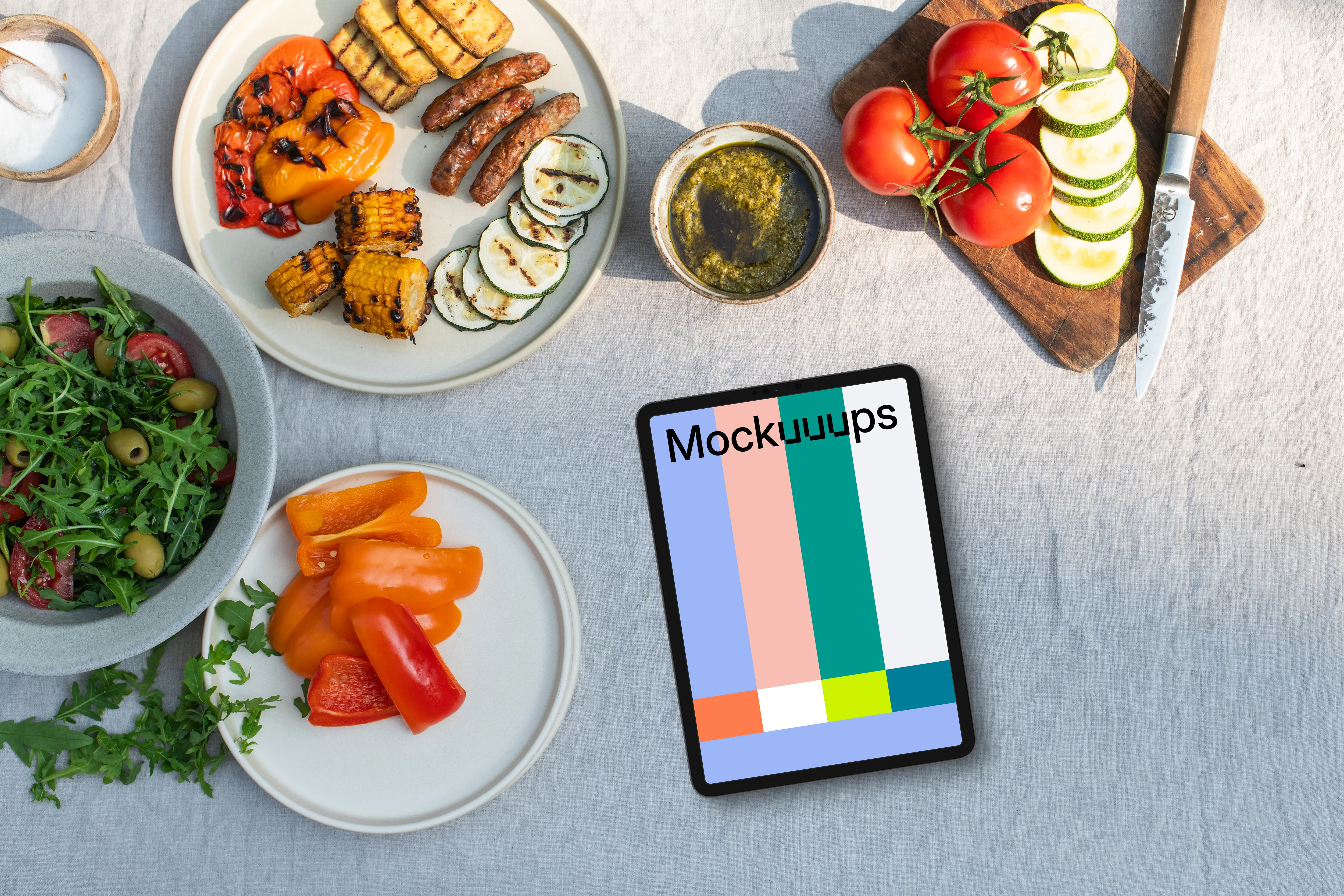 Tablet mockup in the middle of barbecue plates