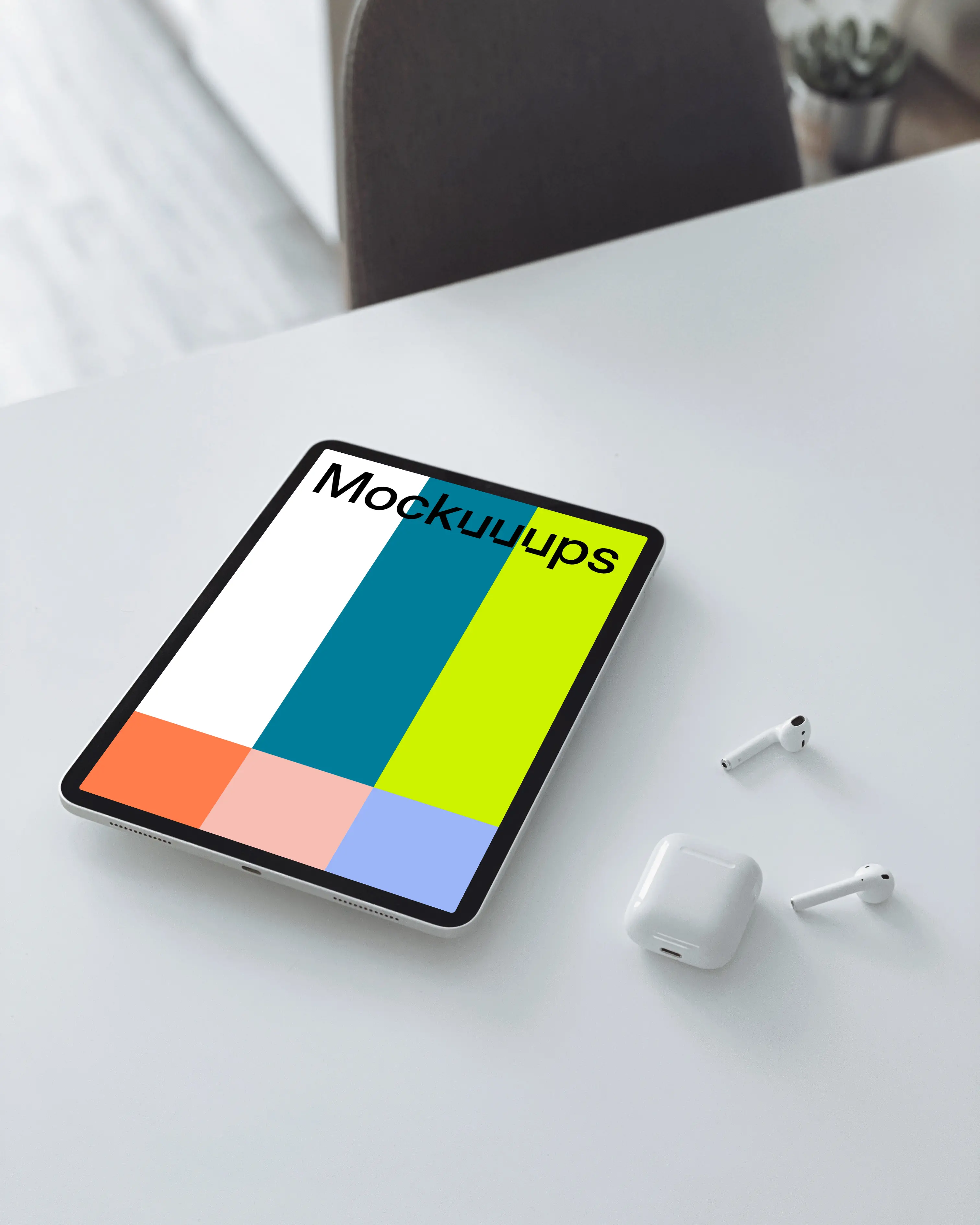 Tablet mockup on a table with a pair of Airpods 2 