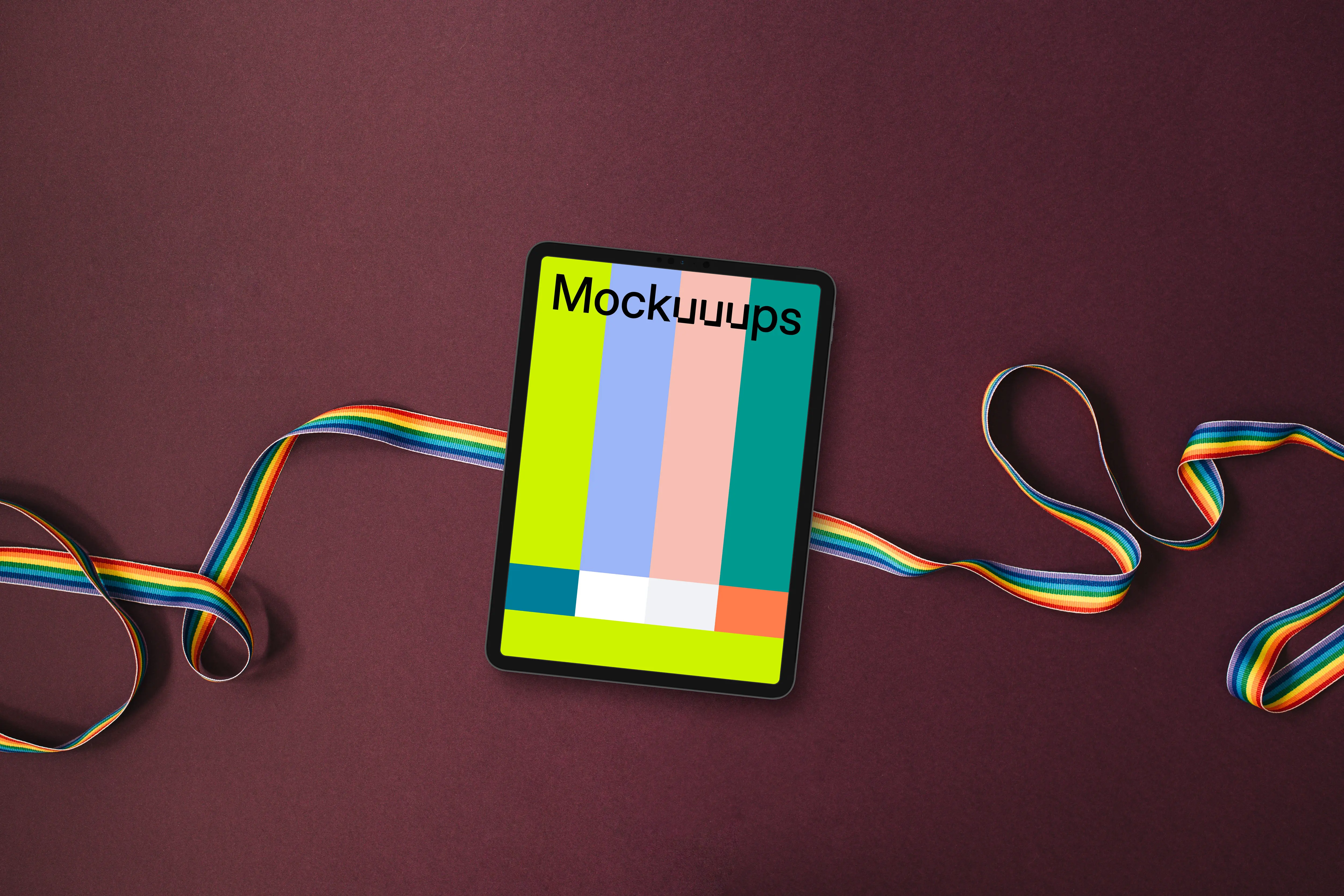 Tablet mockup on a twisted rainbow ribbon
