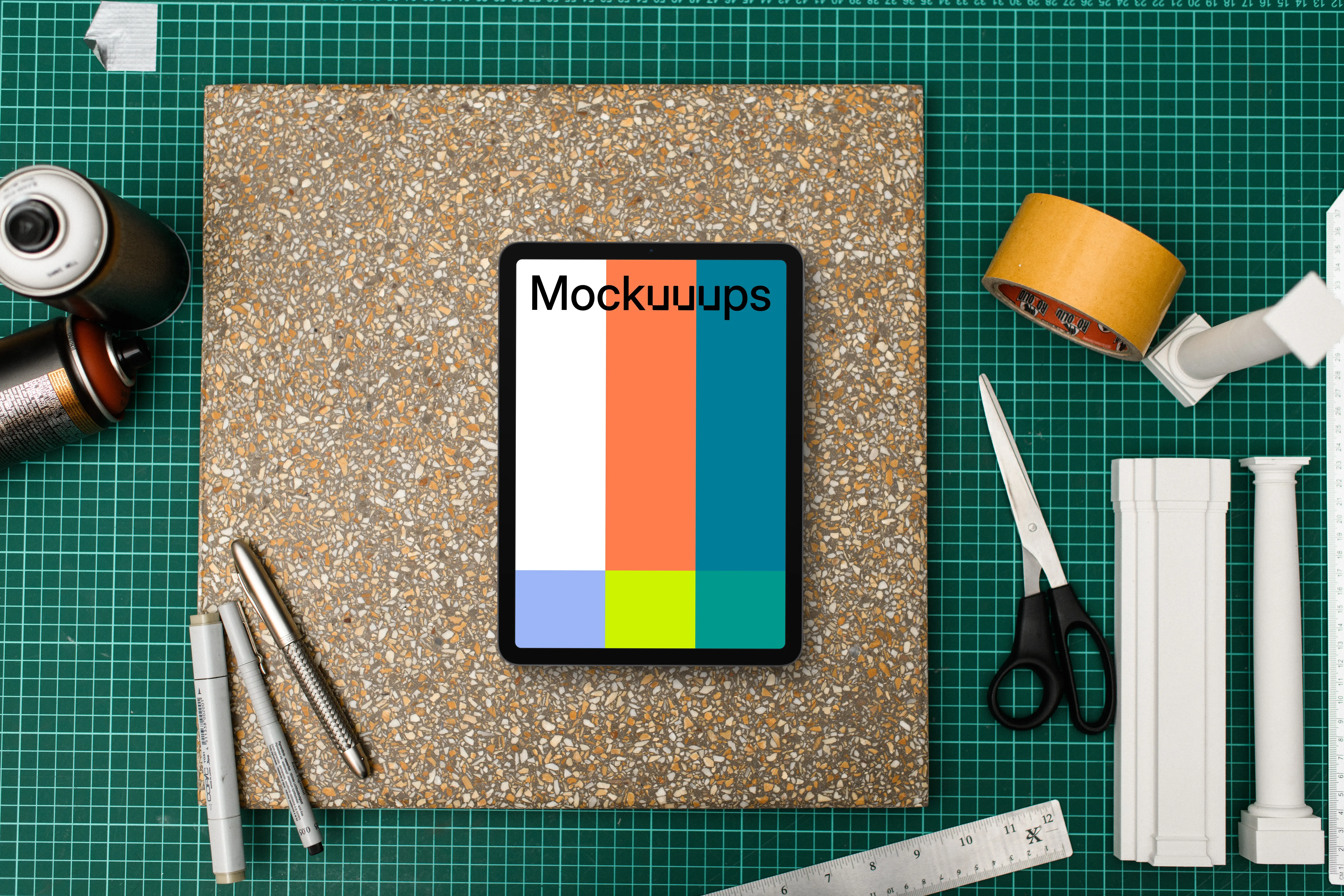 Tablet mockup on architects workspace with tools