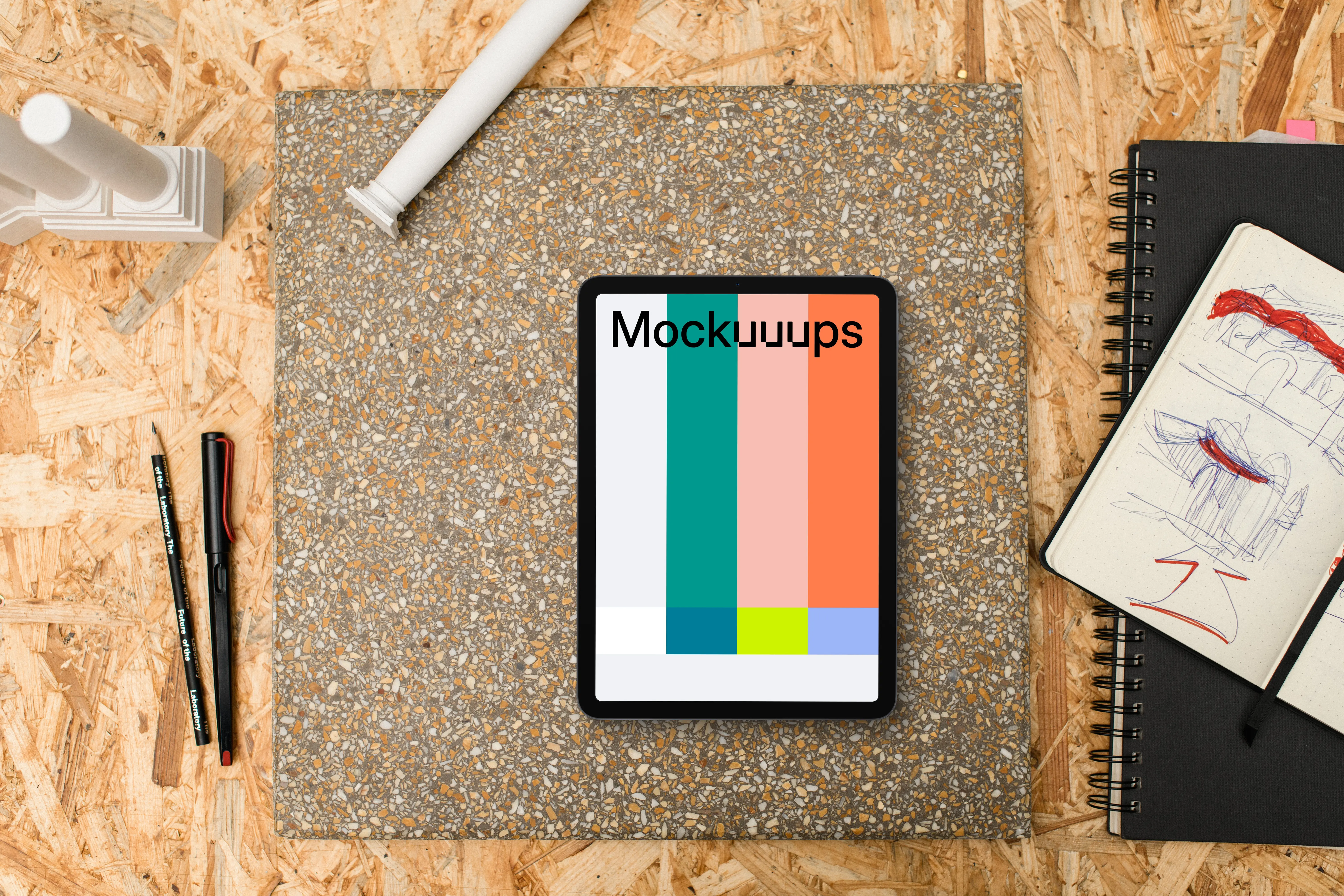 Tablet mockup surrounded by architectural drawing materials