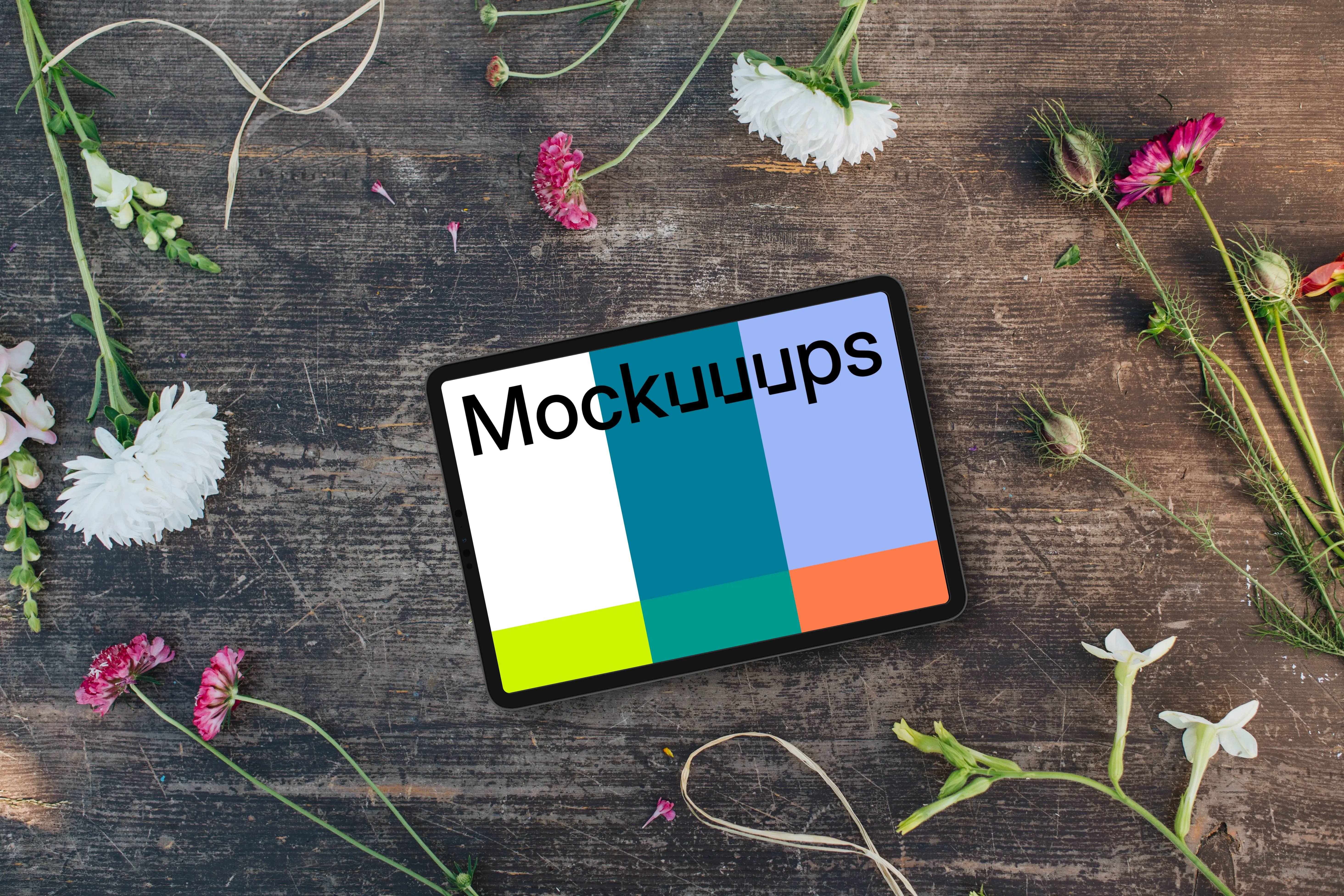 Top view of landscape tablet mockup next to flowers