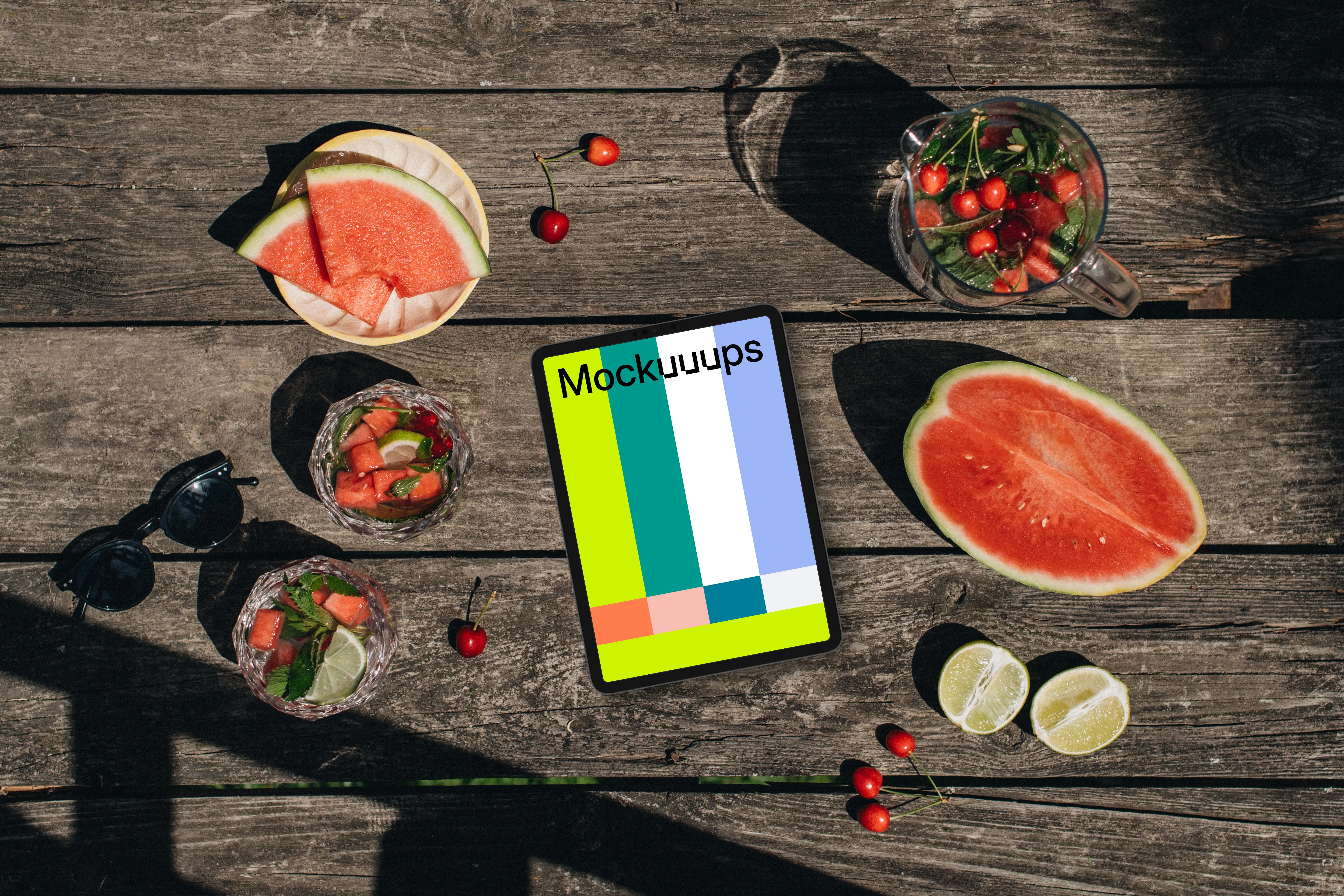 Top view of tablet mockup next to a watermeloon