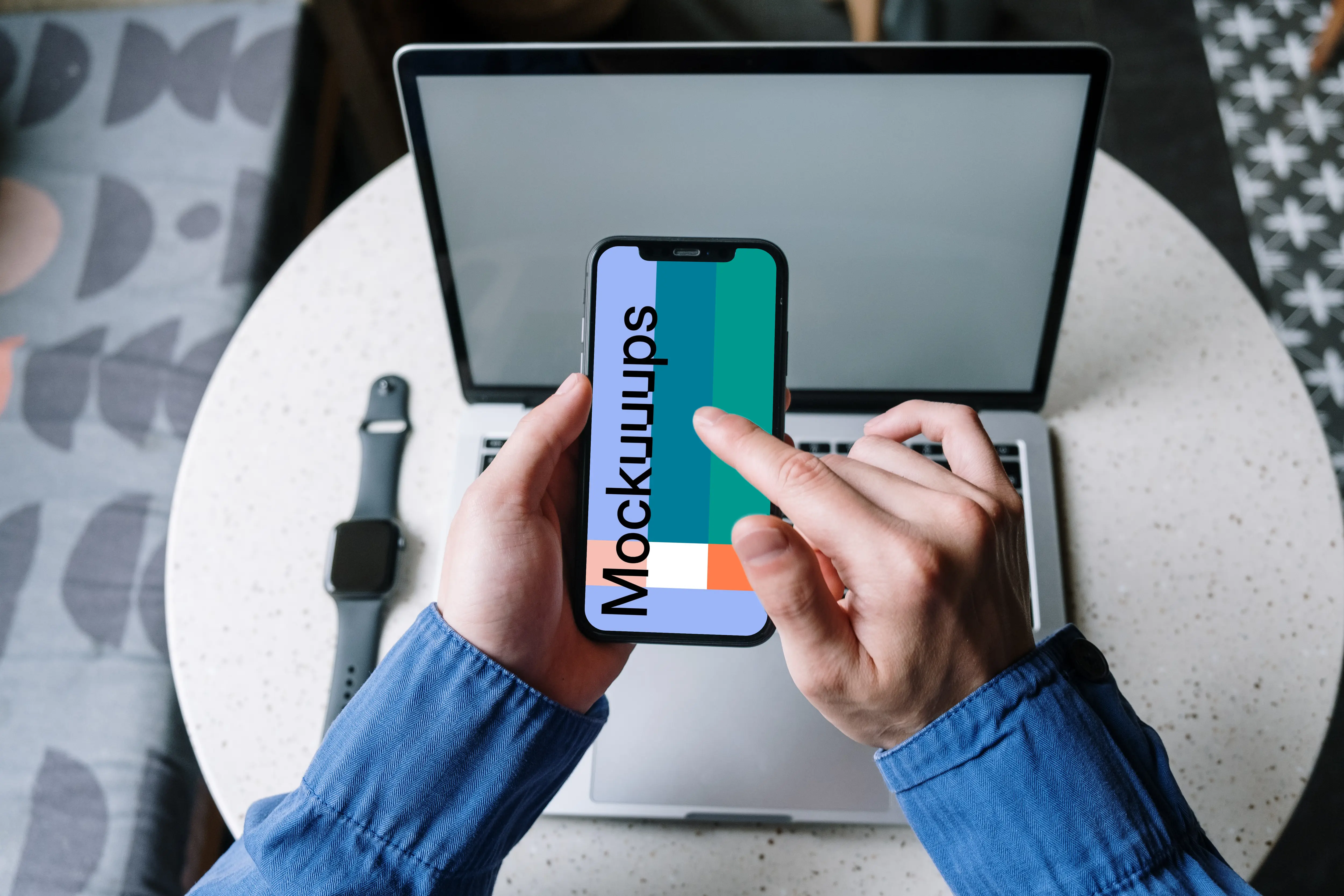 User in blue shirt typing on an iPhone 12 mockup