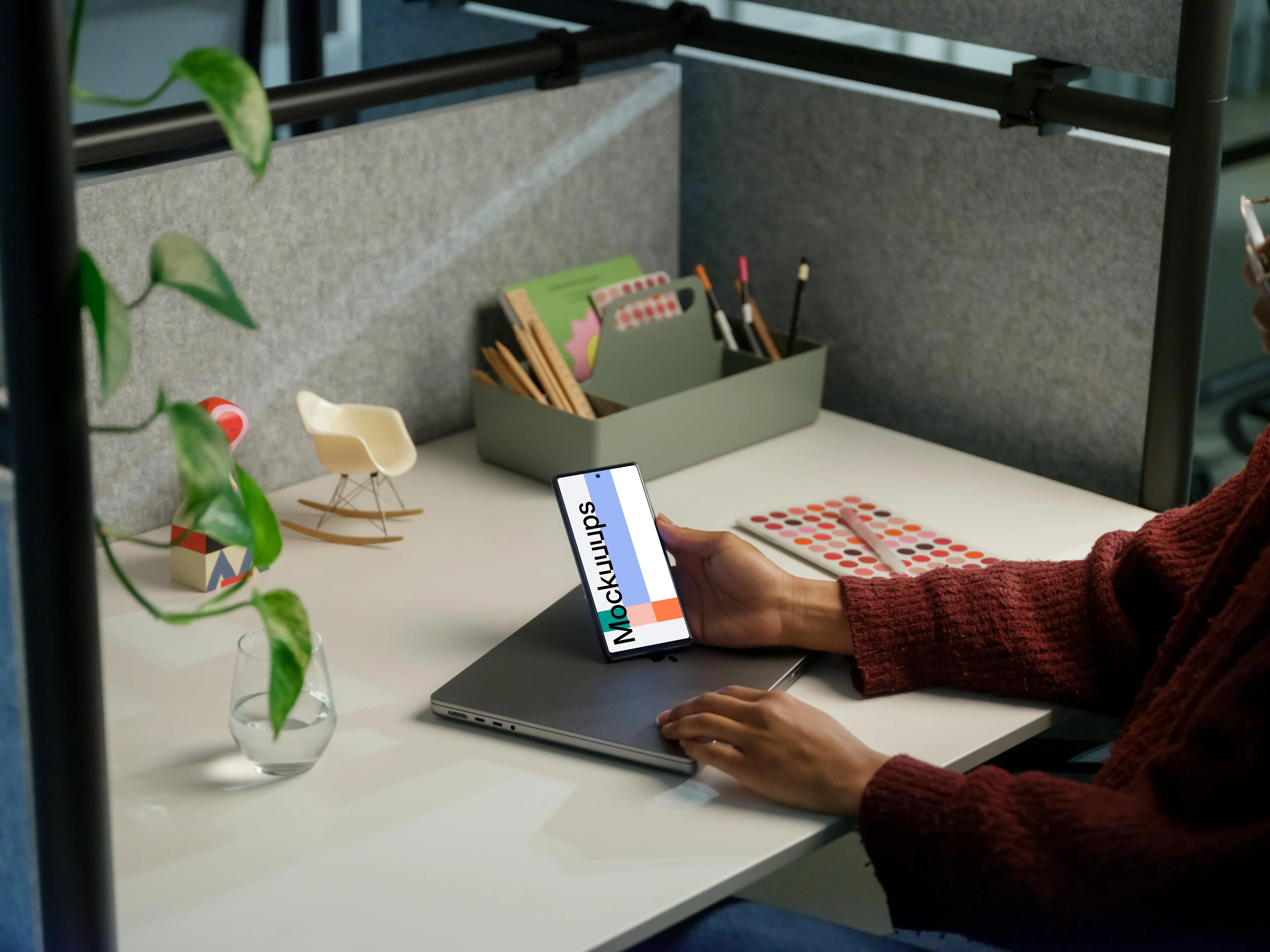 Woman holding a Google Pixel 6 mockup in office