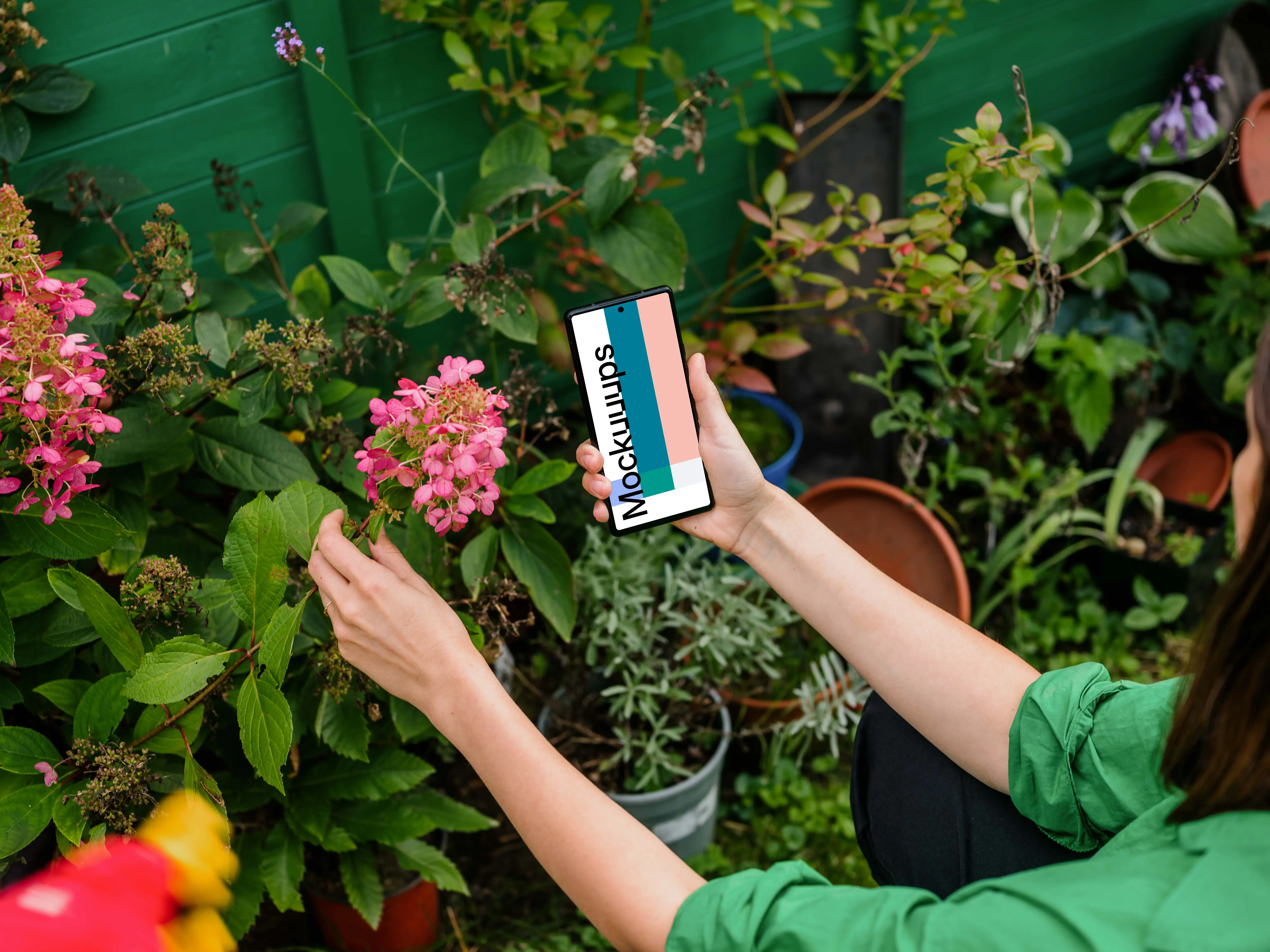 Woman holding a Google Pixel in garden mockup