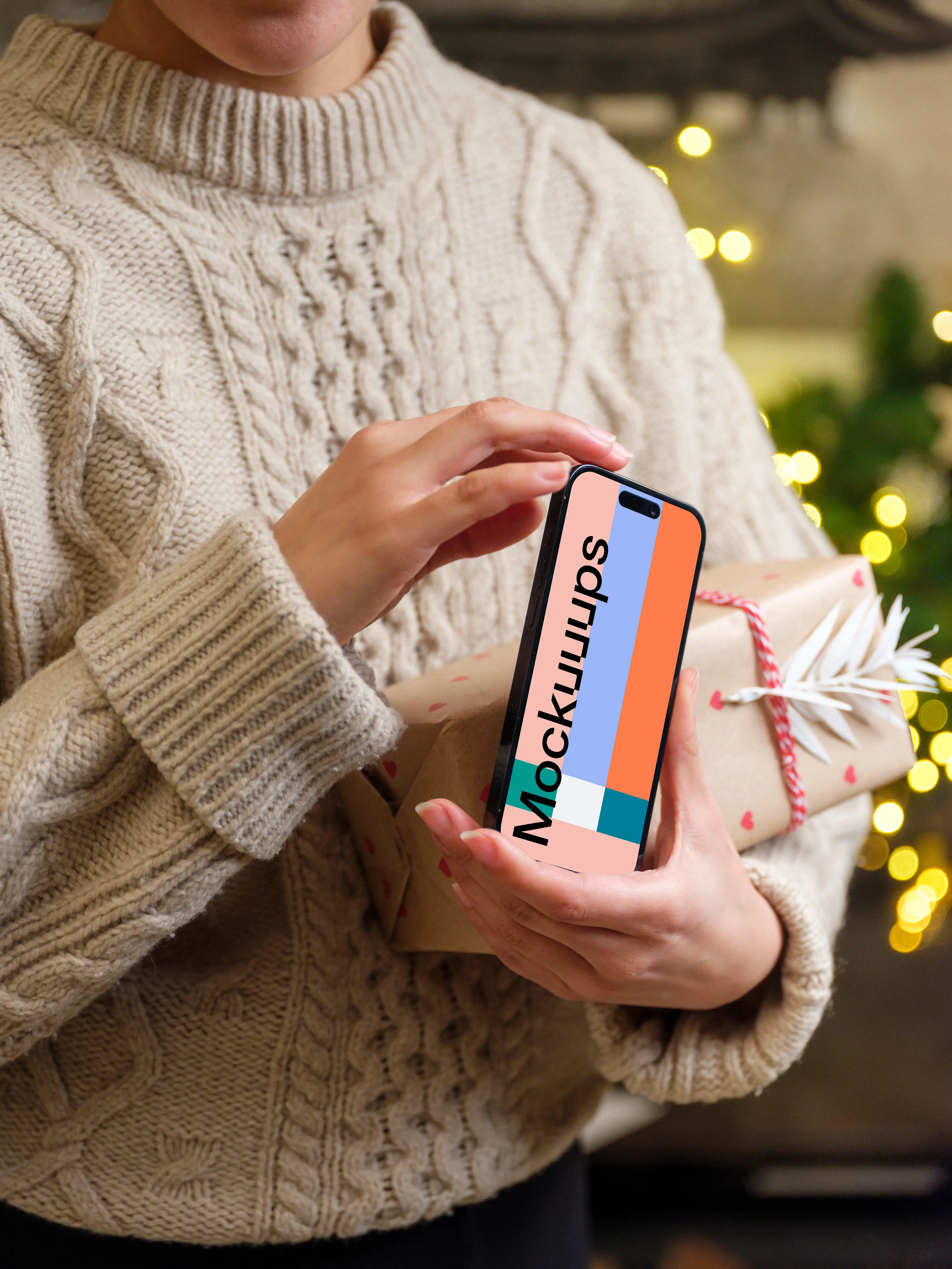 Woman holding a phone mockup in Christmas theme