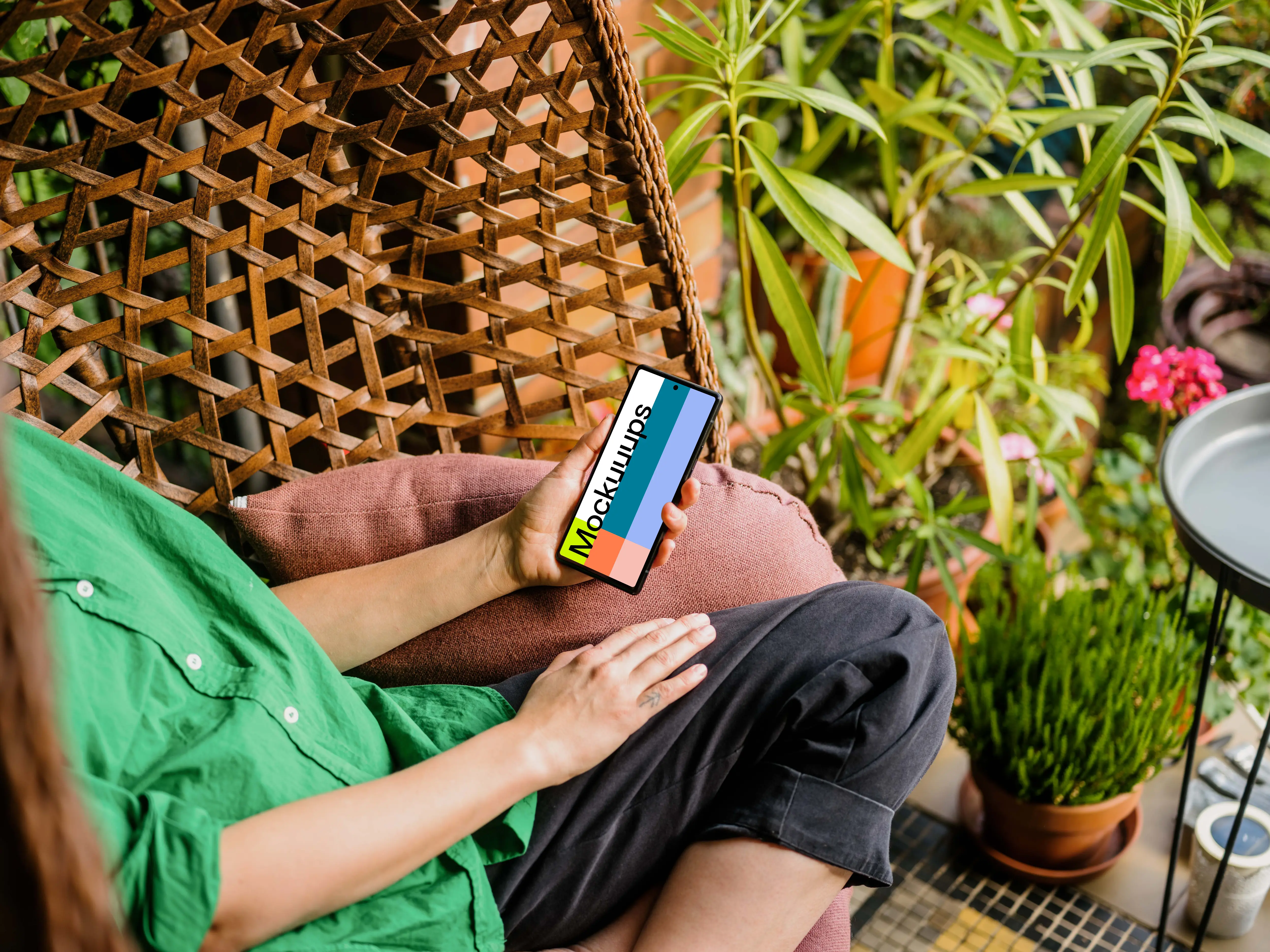 Woman holding a phone mockup surrounded by plants