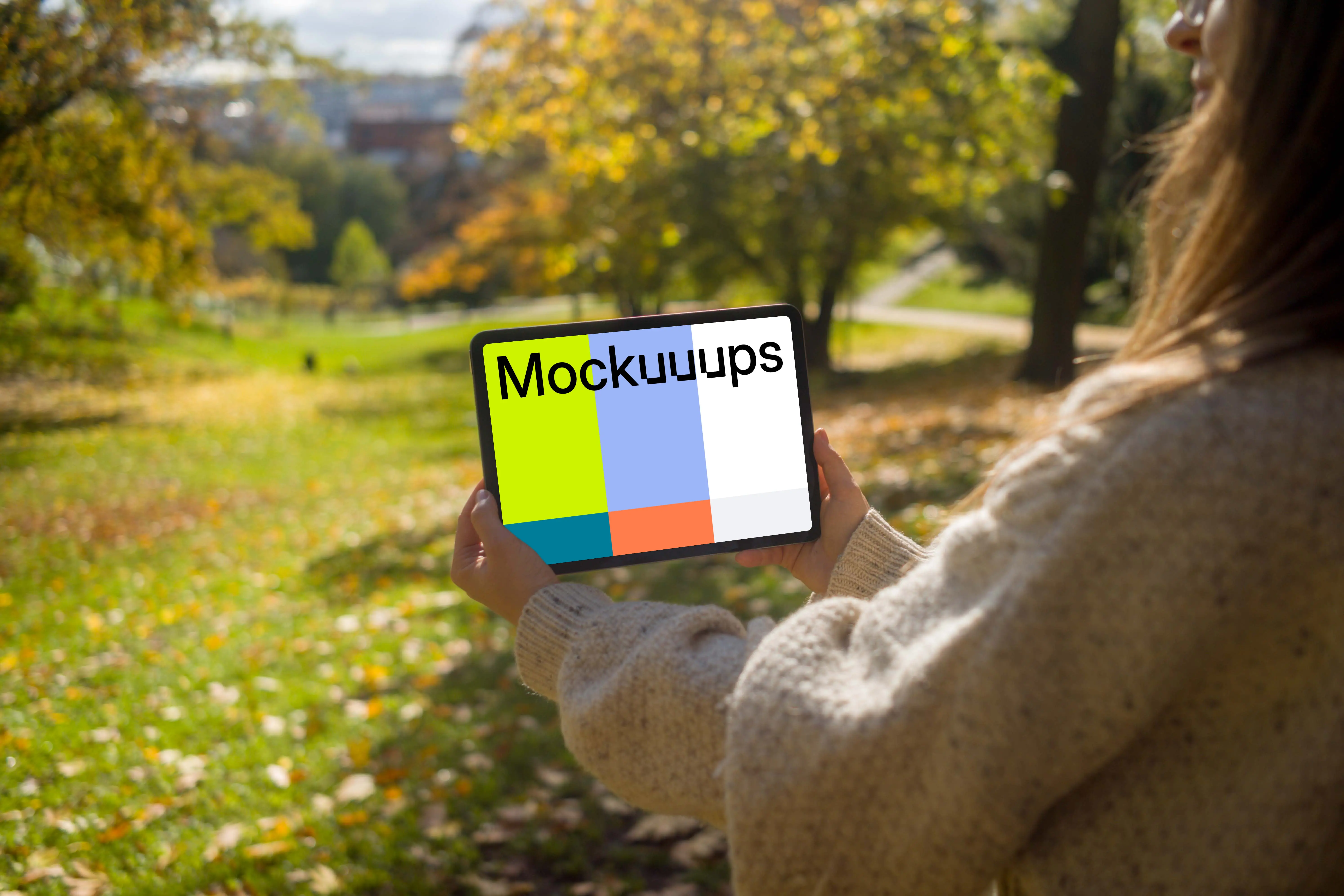 Woman holding a tablet in the garden mockup