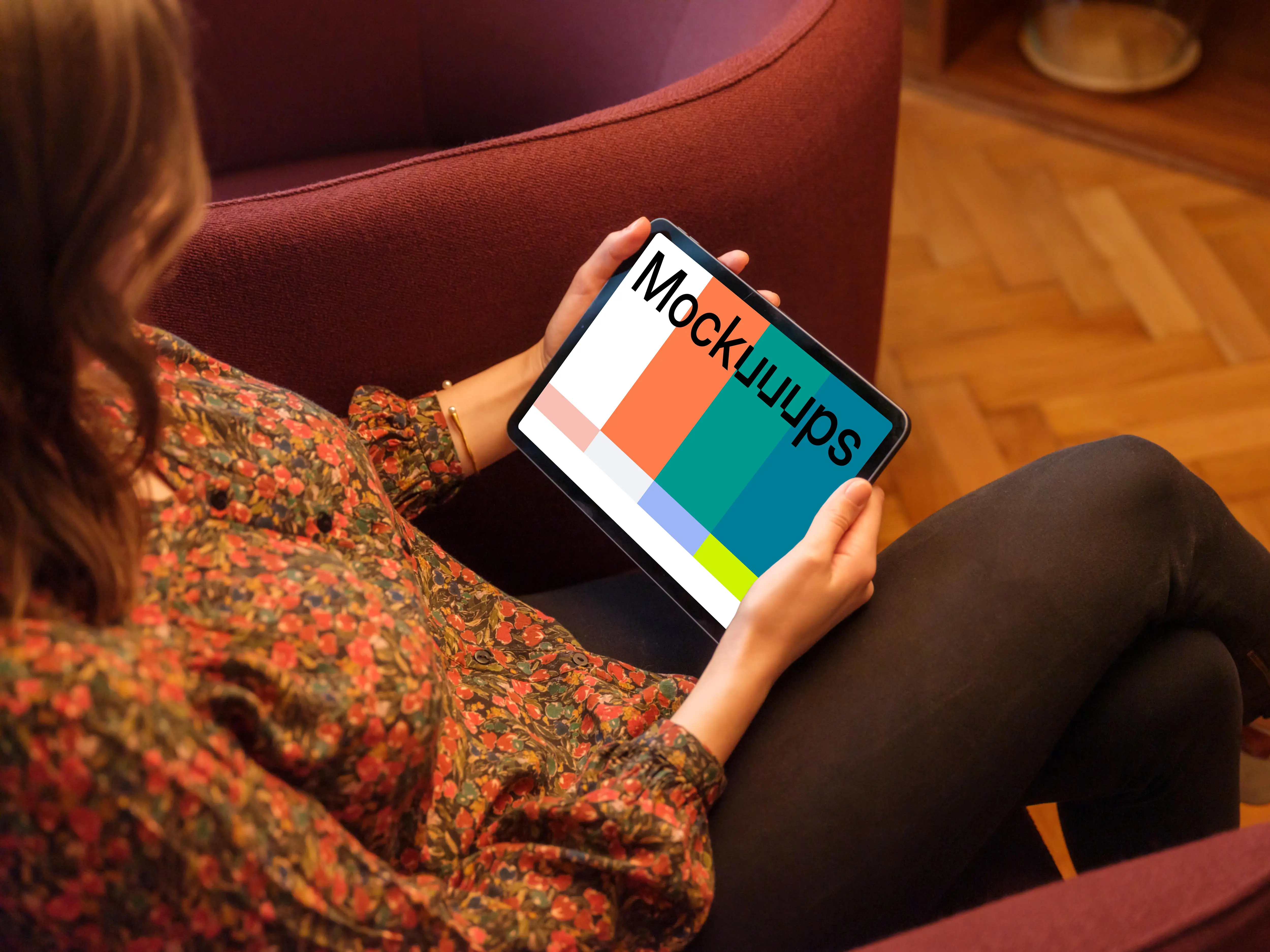 Woman holding a tablet mockup in the lounge