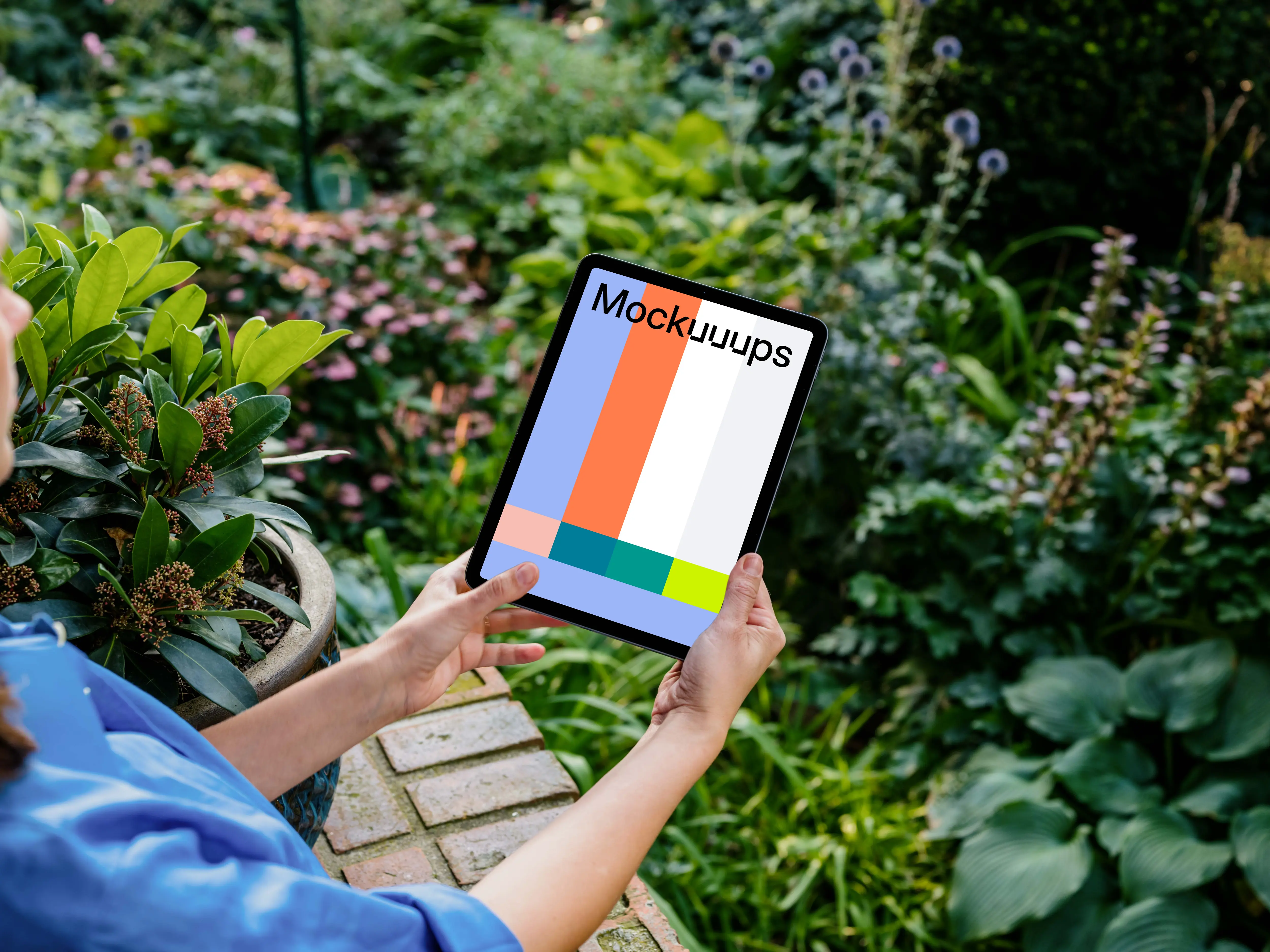Woman holding an iPad Air mockup in garden 