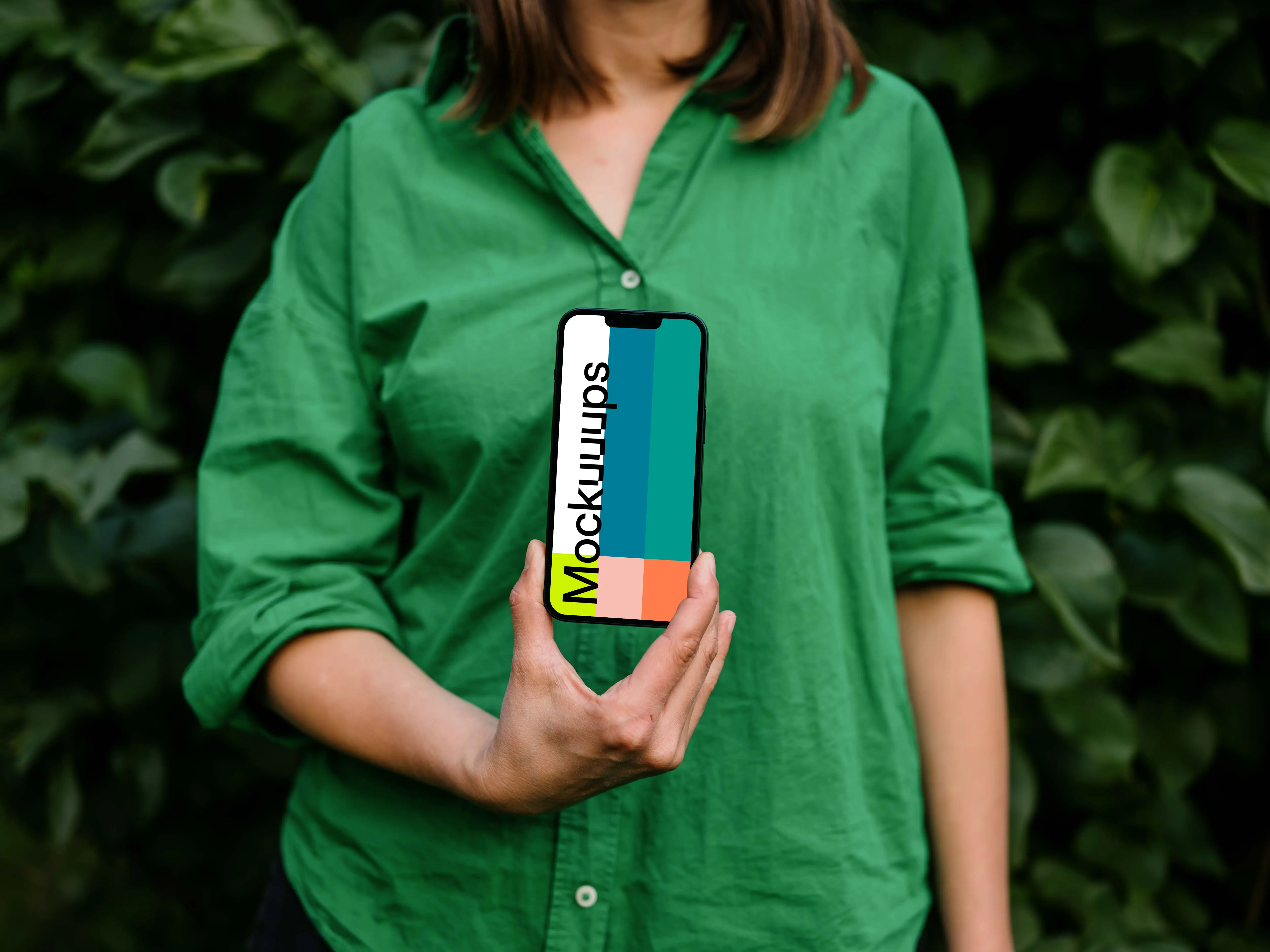 Woman holding an iPhone 13 mockup in green theme