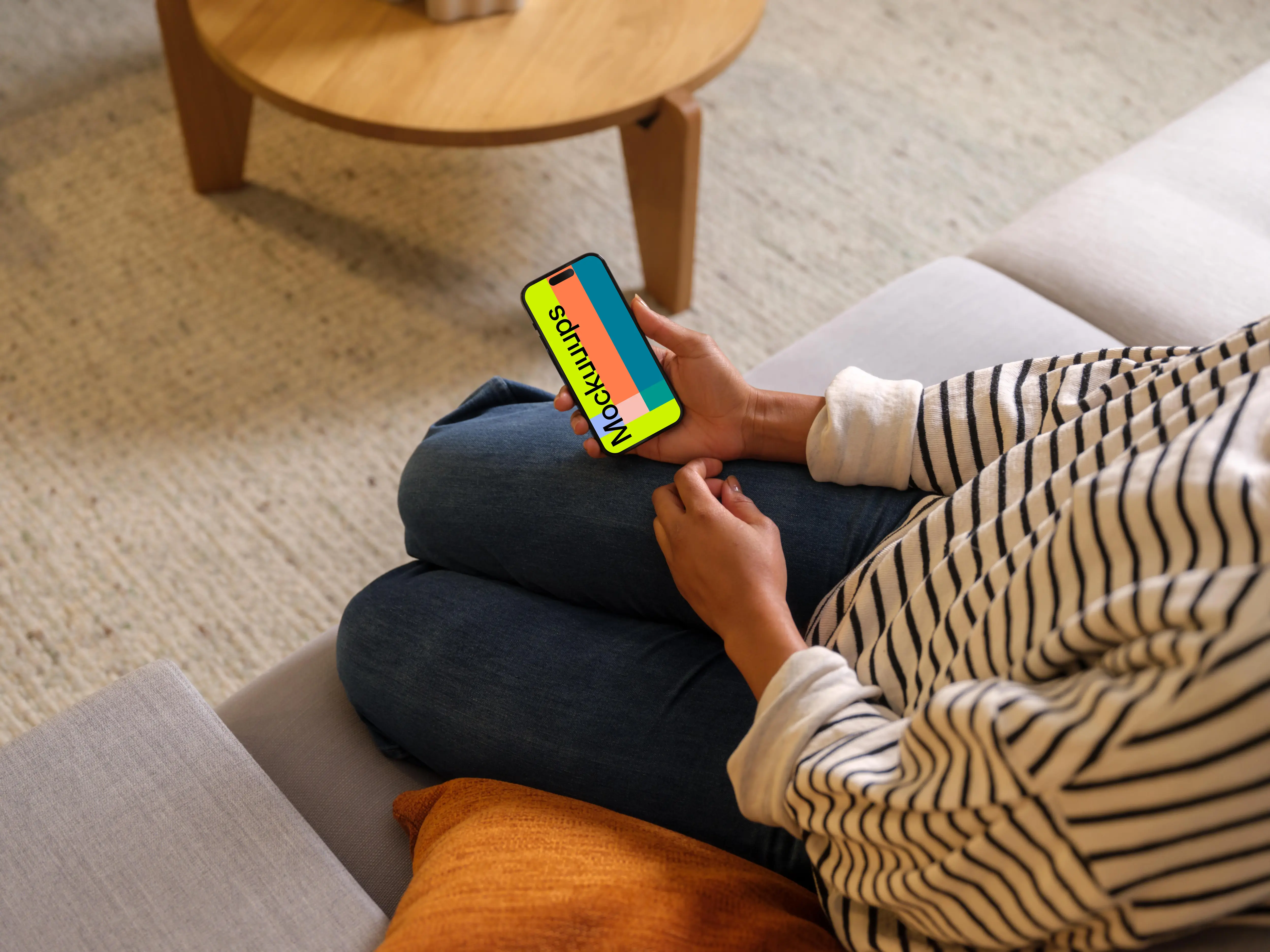 Woman holding an iPhone 14 Pro mockup in cozy place