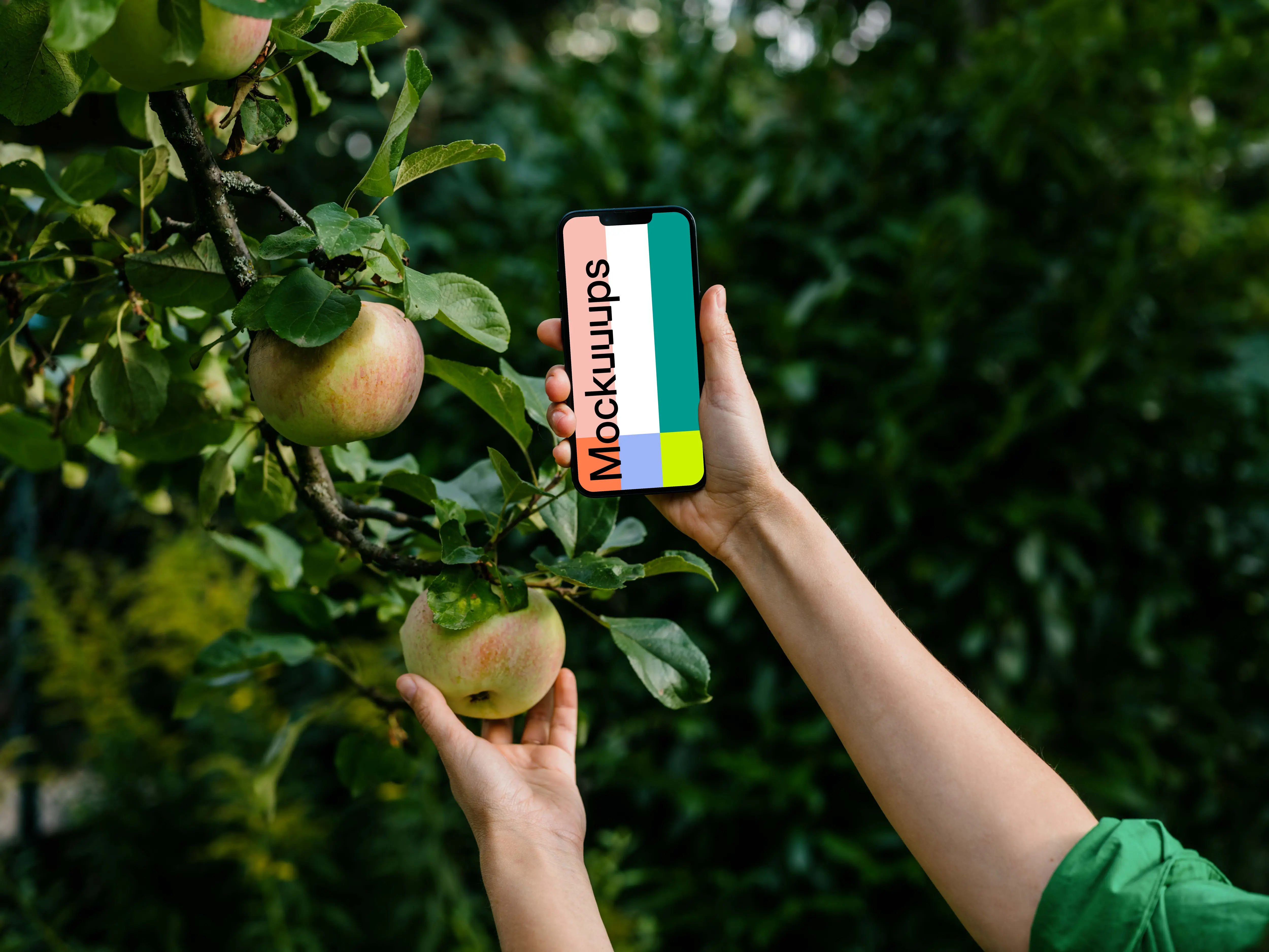 Woman holding an iPhone mockup while grabbing an apple