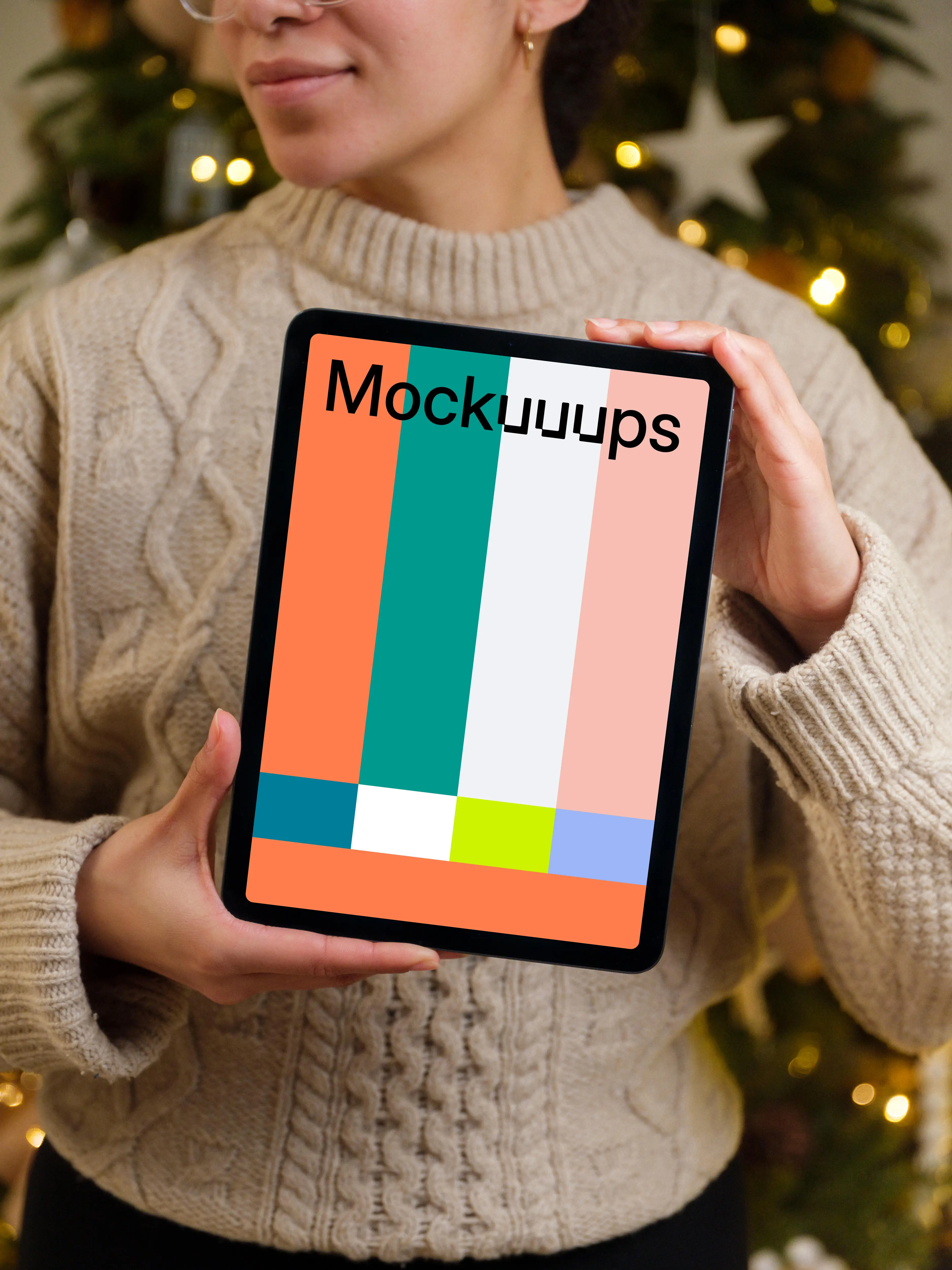 Woman holding iPad mockup next to the Christmas tree