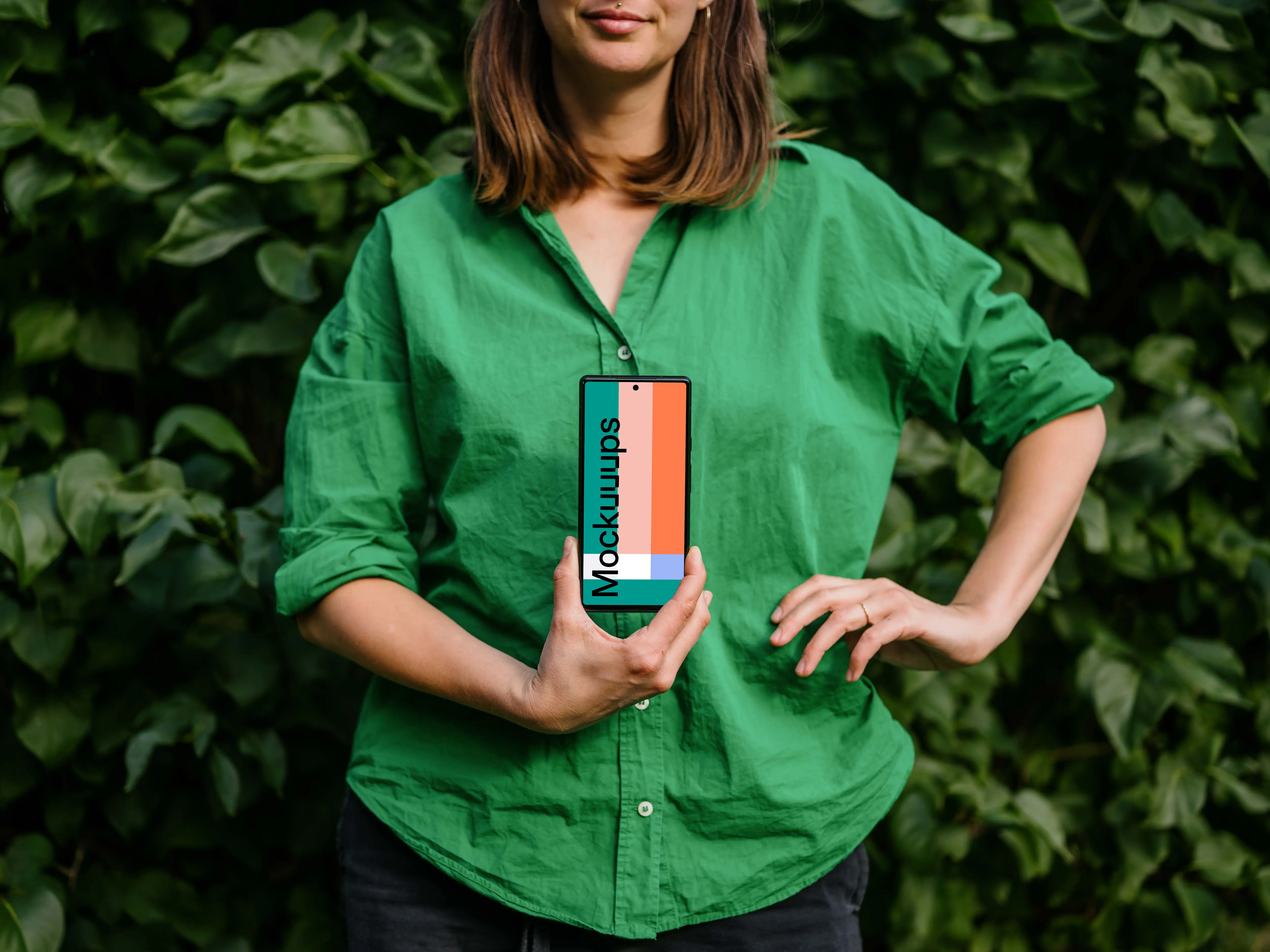Woman in green environment holding a phone mockup 