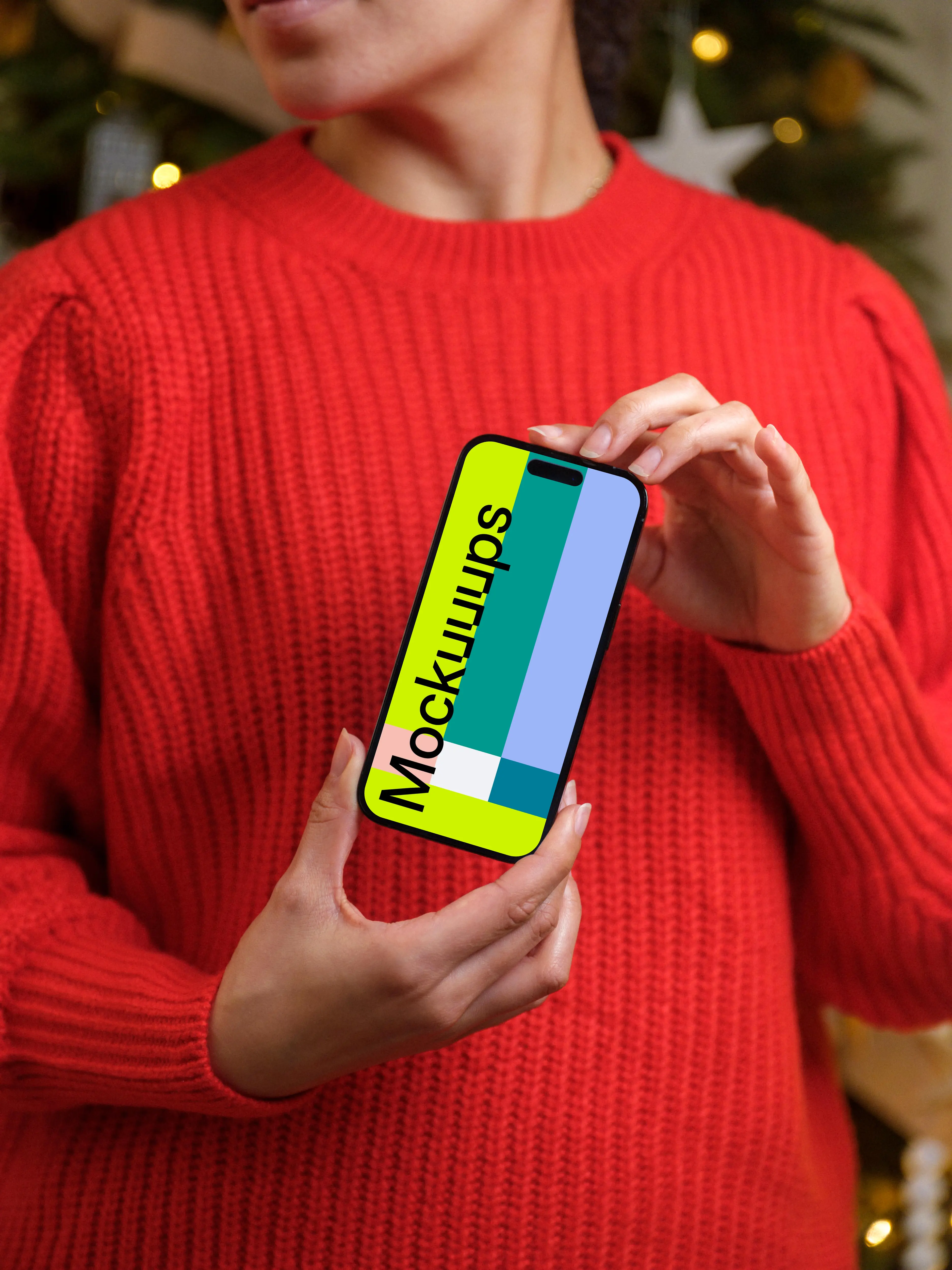 Woman in red sweater holding an iPhone 14 Pro mockup