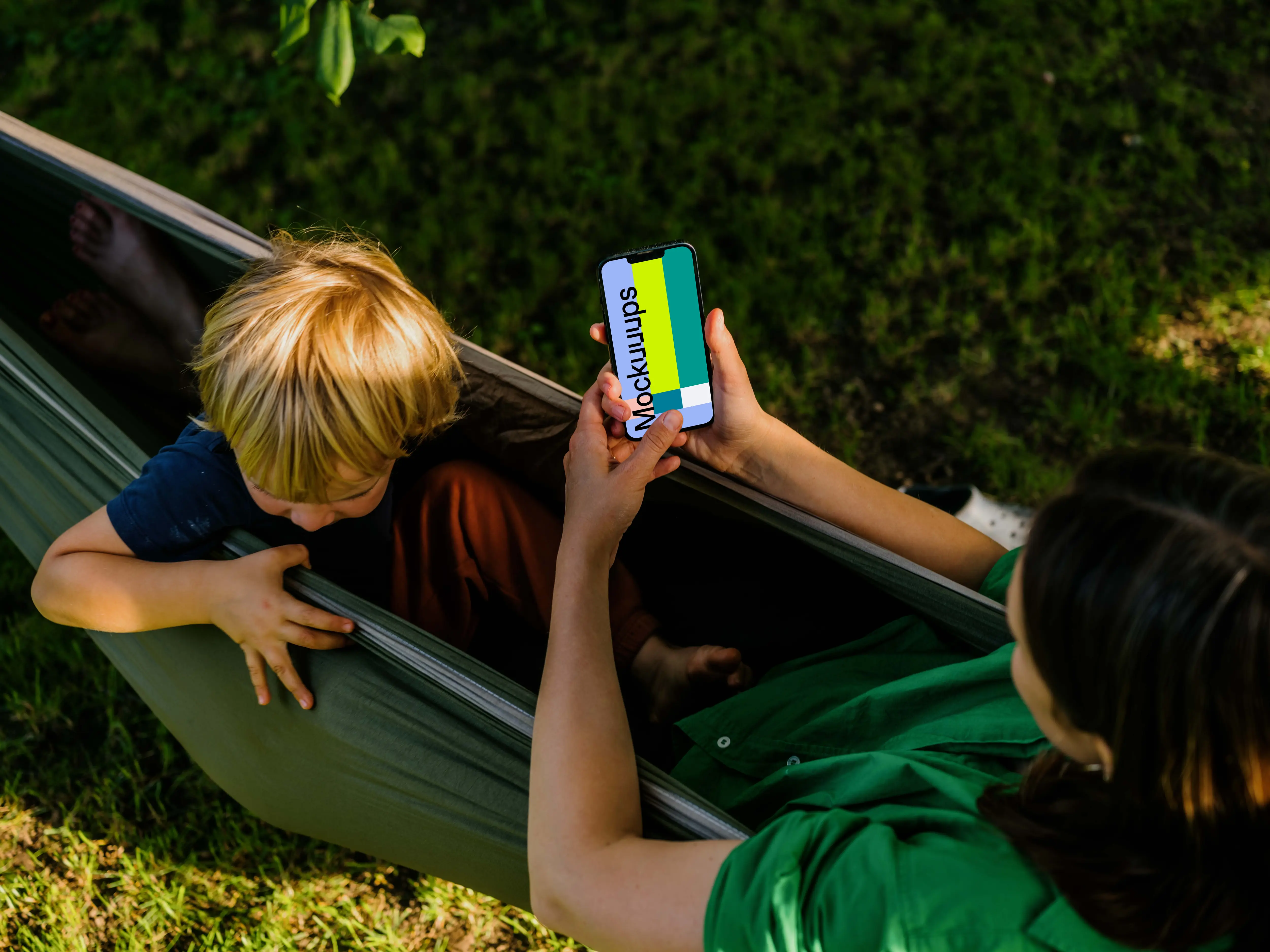 Woman laying in a hammock and typing on an iPhone 13 mockup