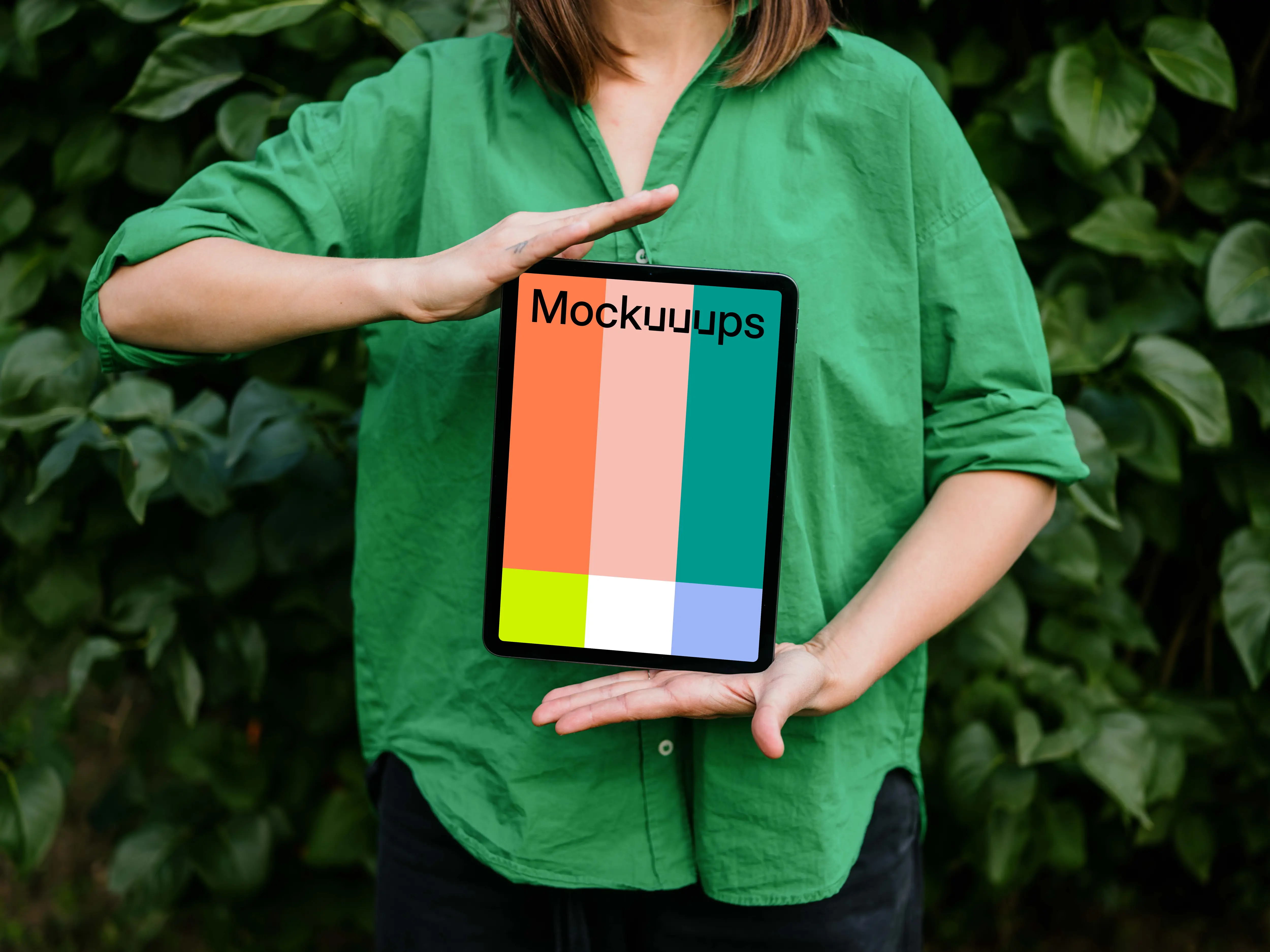 Woman showing off an iPad Air mockup in garden theme