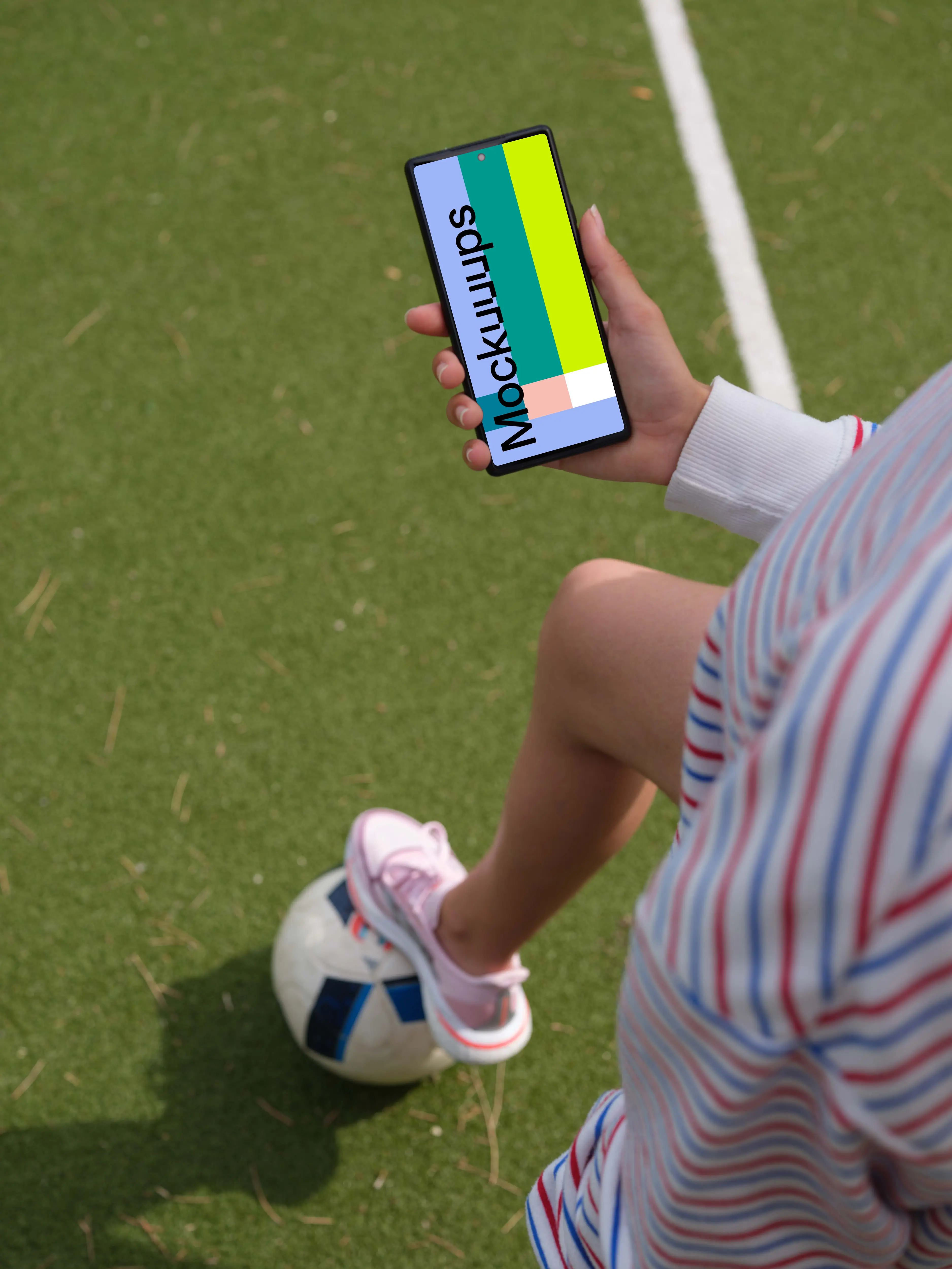 Young footbal player checking on a Google Pixel 6 mockup
