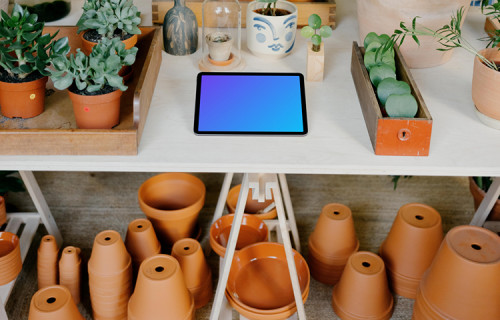 iPad Air mockup on a white table in an indoor garden