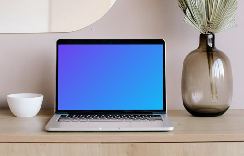 MacBook mockup on a table with mirror in the background 