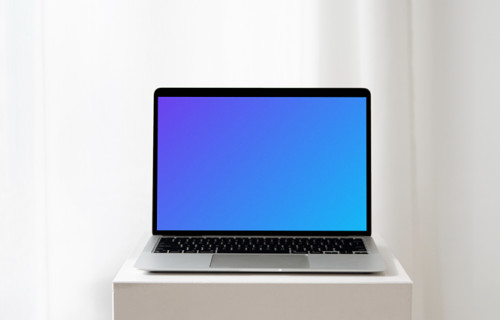 MacBook mockup on a white table in an all white background