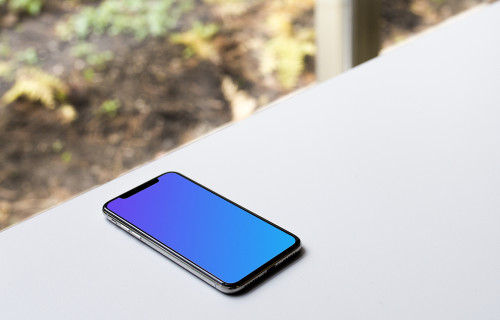 Bright view of iPhone X mockup on the table