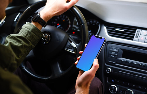 Driver holding an iPhone 11 mockup with hand on wheel