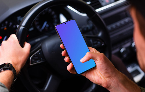 Driver parked up tapping Samsung S20 mockup at the wheel