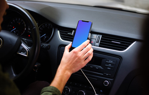 Driver placing iPhone 11 mockup in car mount