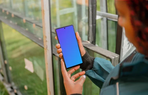 Female construction worker holding a Google Pixel mockup