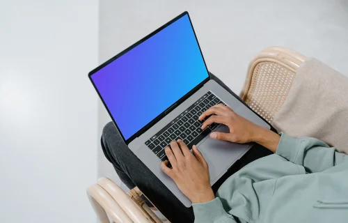 Grey MacBook mockup on user’s laps