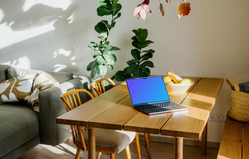 Grey MacBook Pro mockup on a table in a living room