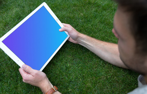 Holding iPad Pro mockup (Landscape)