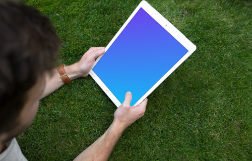 Holding iPad Pro mockup on the green background
