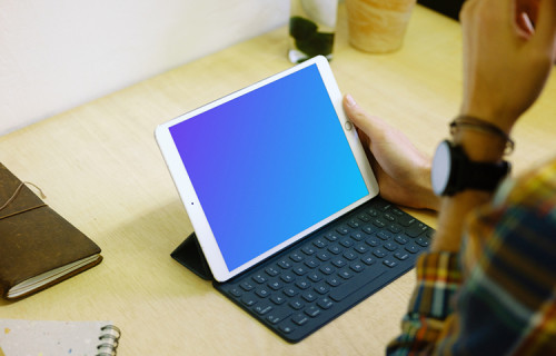Holding iPad Pro mockup with keyboard