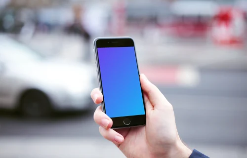 Holding iPhone 6 mockup and crossing the street