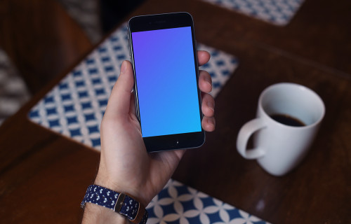 Holding iPhone 6 mockup and drinking coffee