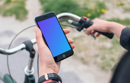 Holding iPhone 6 mockup on a bike