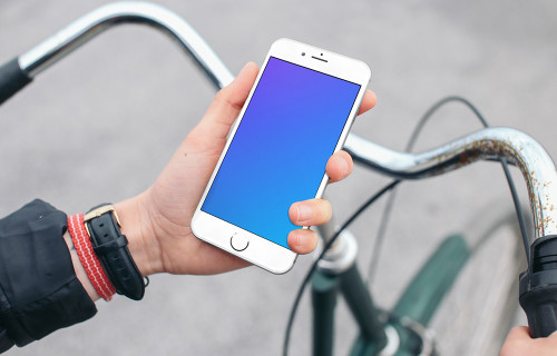 Holding iPhone 6s mockup on a Bike